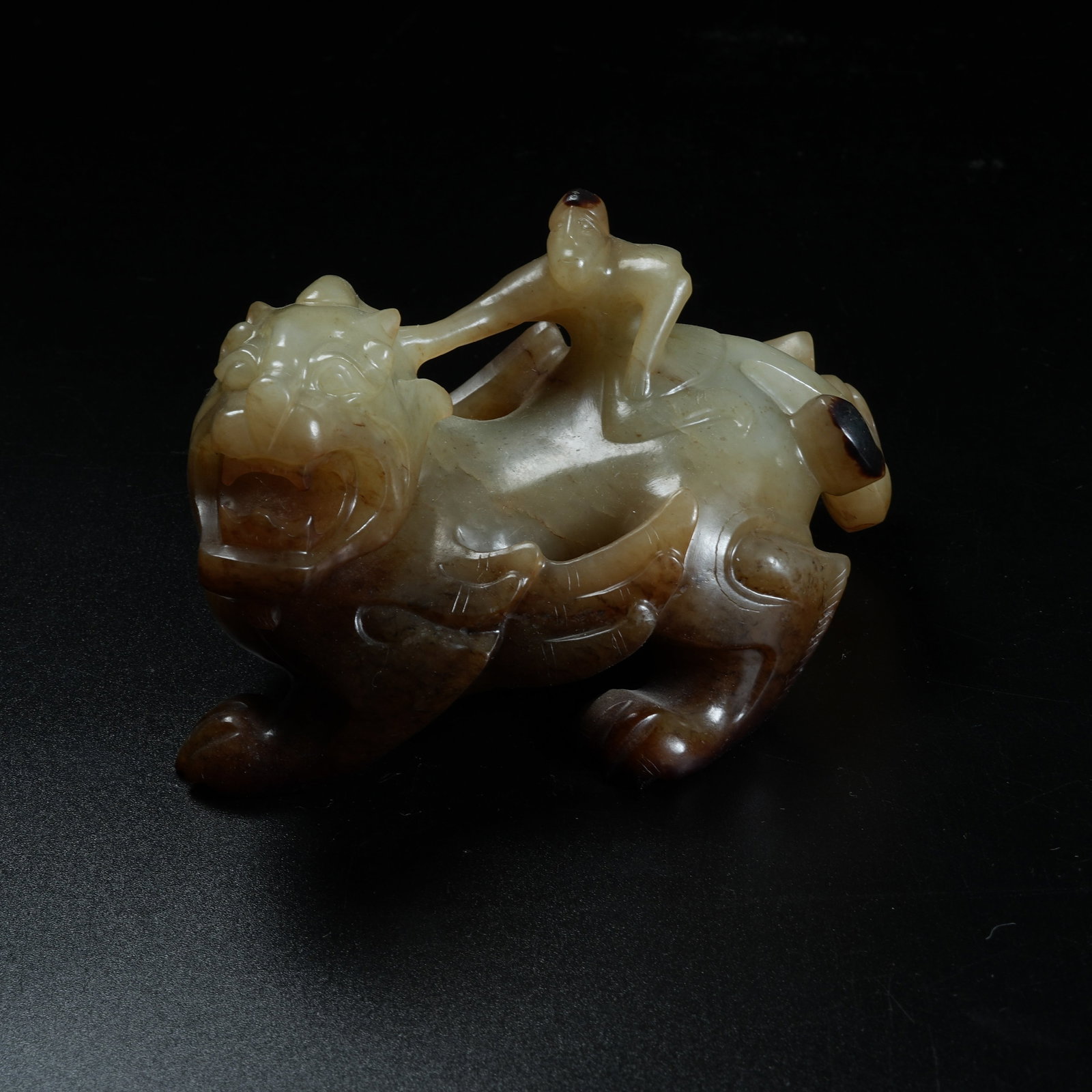 A ARCHAIC JADE ORNAMENT OF WINGED IMMORTAL RIDING BEAST: Archaic Jade Ornament of Winged Immortal Riding Beast