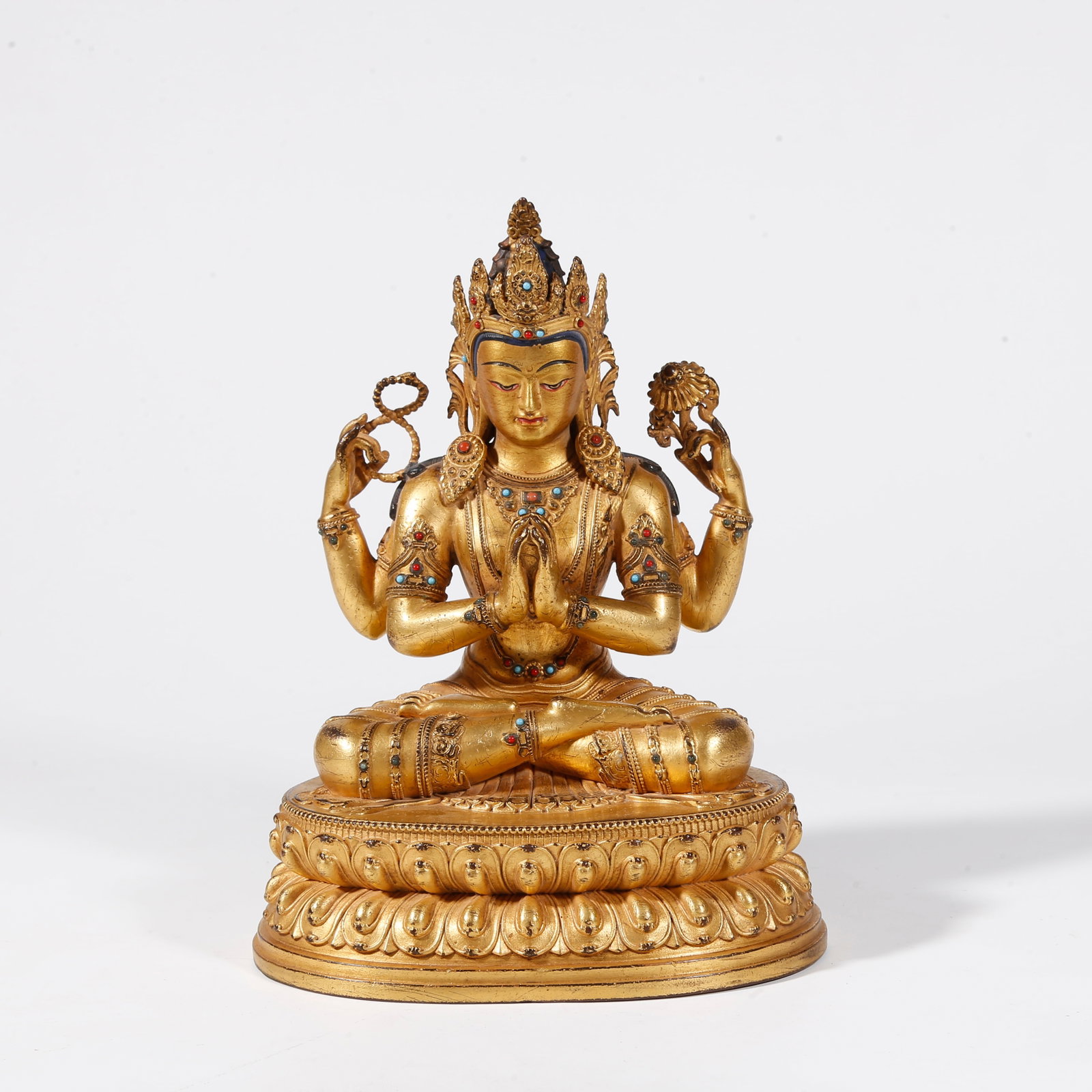 A GILT BRONZE STATUE OF FOUR-ARMED GUANYIN: Gilt Bronze Statue of Four-Armed Guanyin