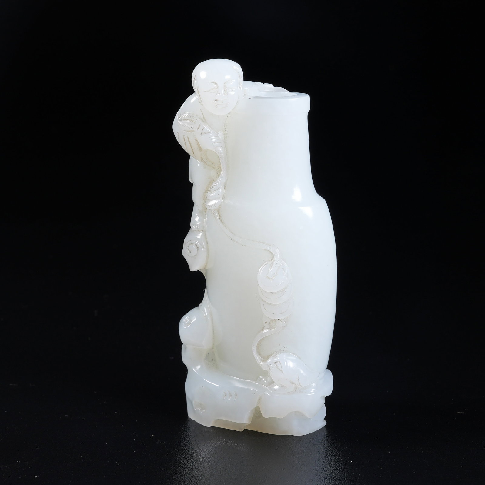 A WHITE HETIAN JADE FLOWER HOLDER DEPICTING LIU HAI PLAYING WITH GOLDEN TOAD: White Hetian jade flower holder depicting Liu Hai playing with golden toad