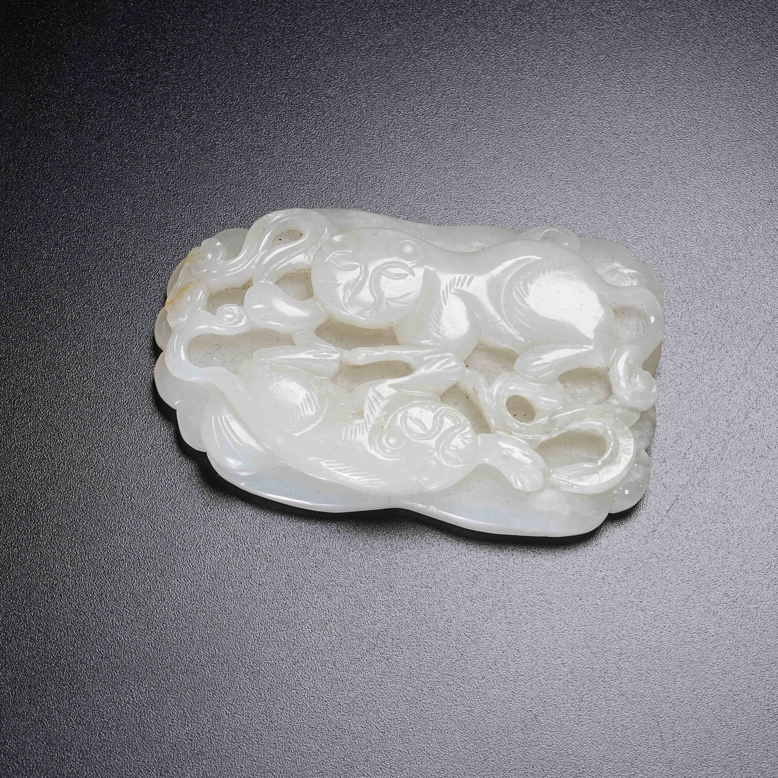 A HETIAN JADE AUSPICIOUS BEAST PENDANT (1 of 9)
