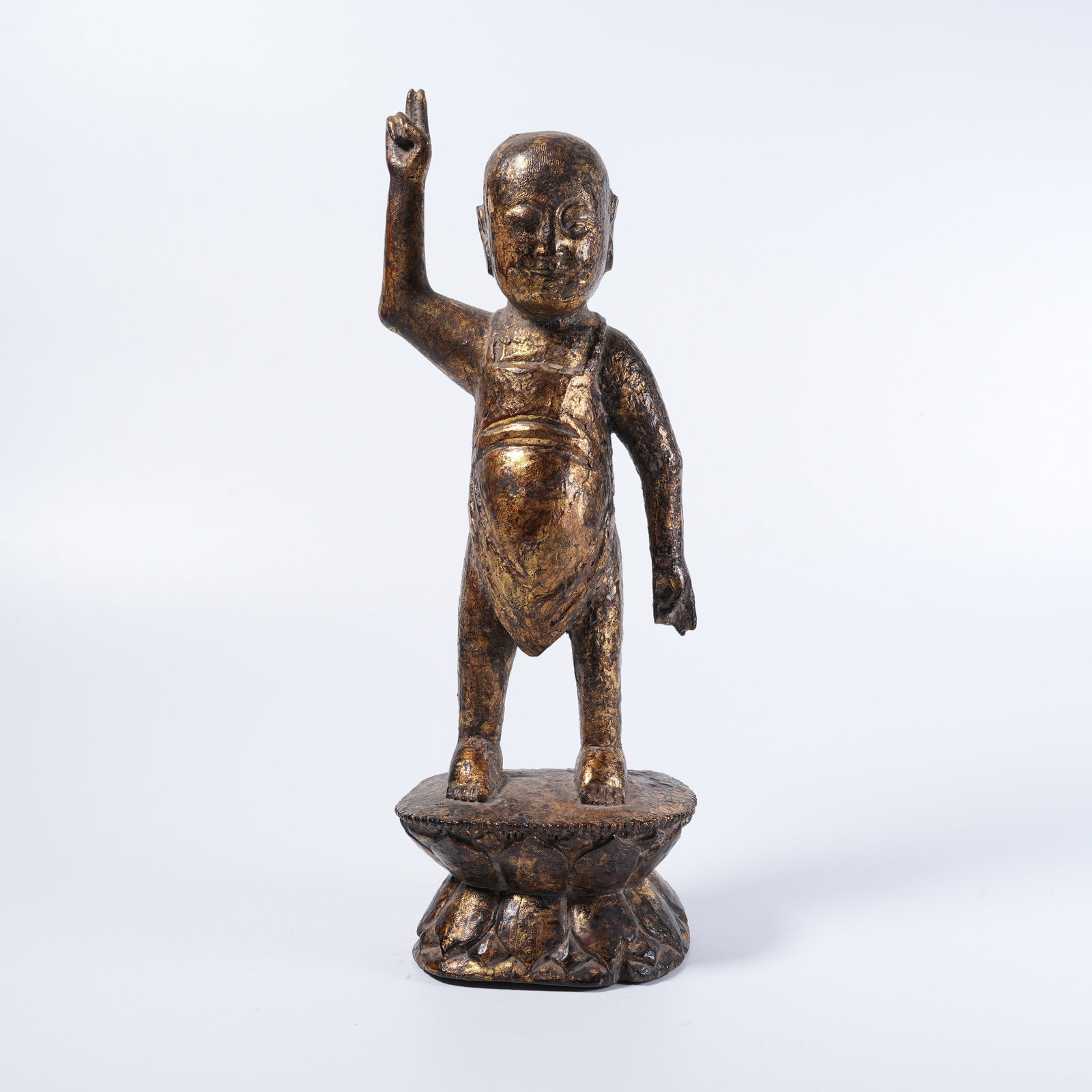 A GILT-LACQUERED WOOD-CORE STATUE OF NEWBORN SAKYAMUNI: Gilt-lacquered wood-core statue of newborn Sakyamuni