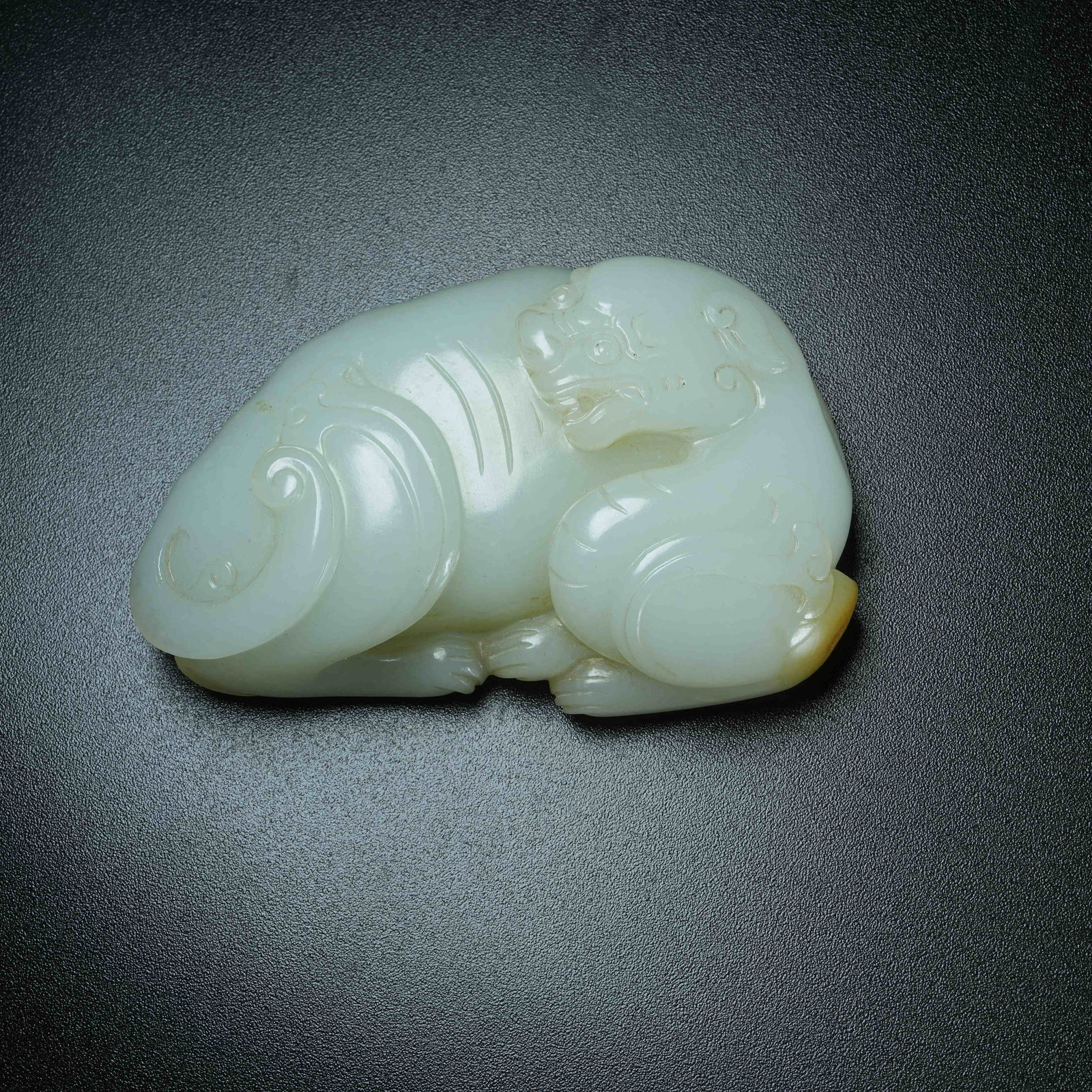 A ORNAMENT OF AUSPICIOUS BEAST IN HETIAN JADE (1 of 8)