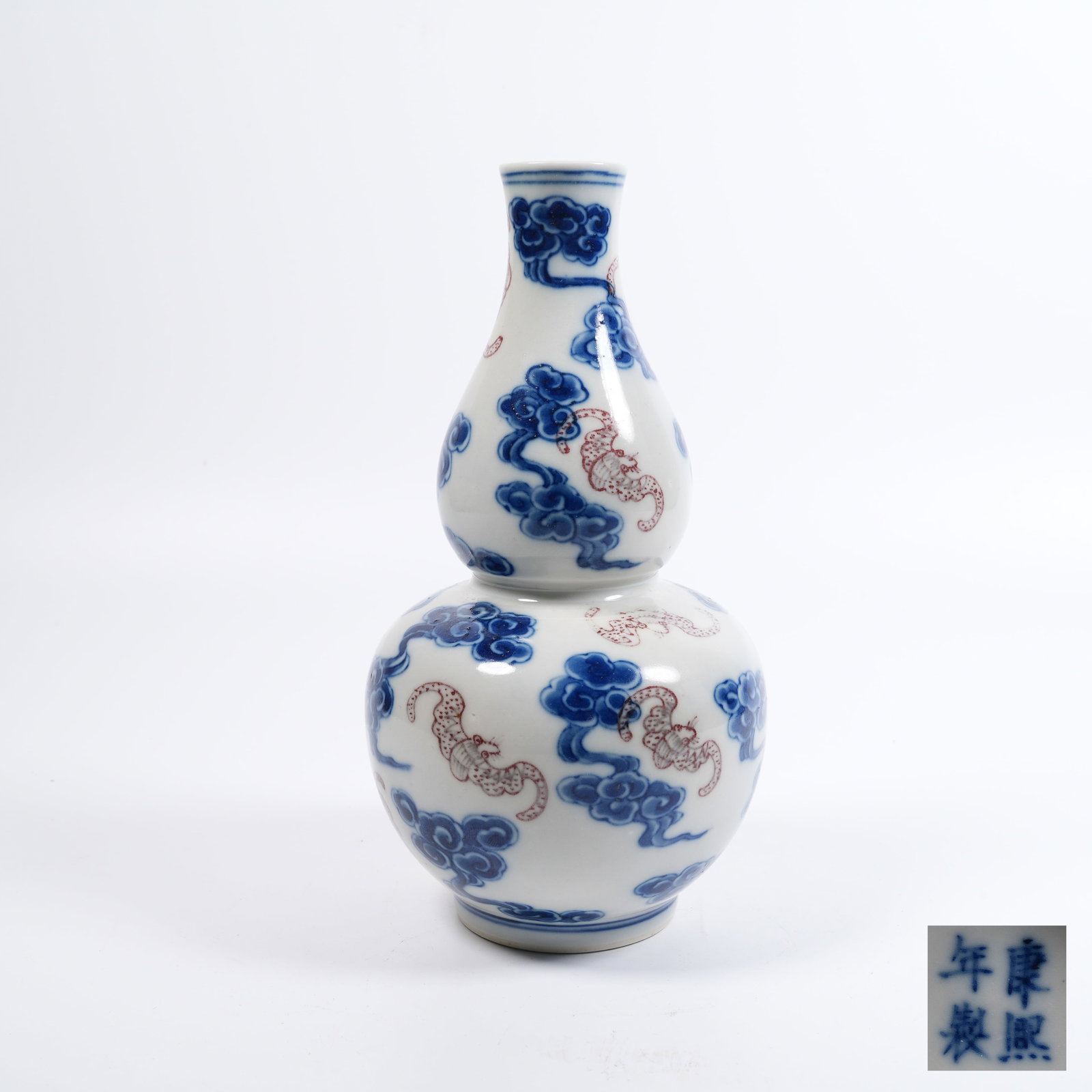 A BLUE-AND-WHITE UNDERGLAZE-RED GOURD-SHAPED VASE WITH FORTUNE-CLOUD PATTERN: Blue-and-white underglaze-red gourd-shaped vase with fortune-cloud pattern