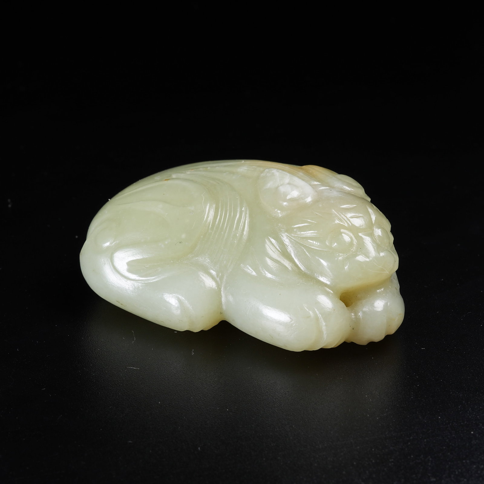 A HETIAN JADE RECUMBENT BEAST PENDANT (1 of 8)