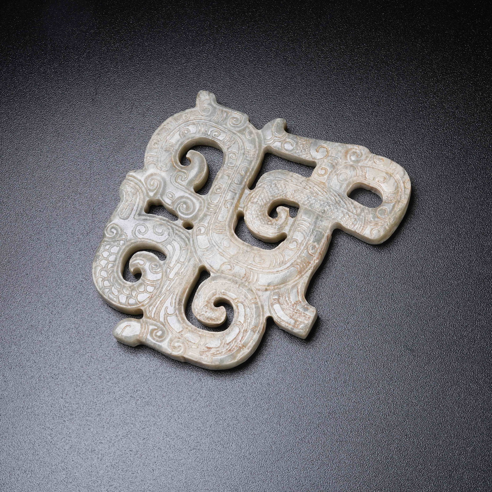 A ARCHAIC JADE PENDANT WITH COILED DRAGON PATTERN: Archaic Jade Pendant with Coiled Dragon Pattern