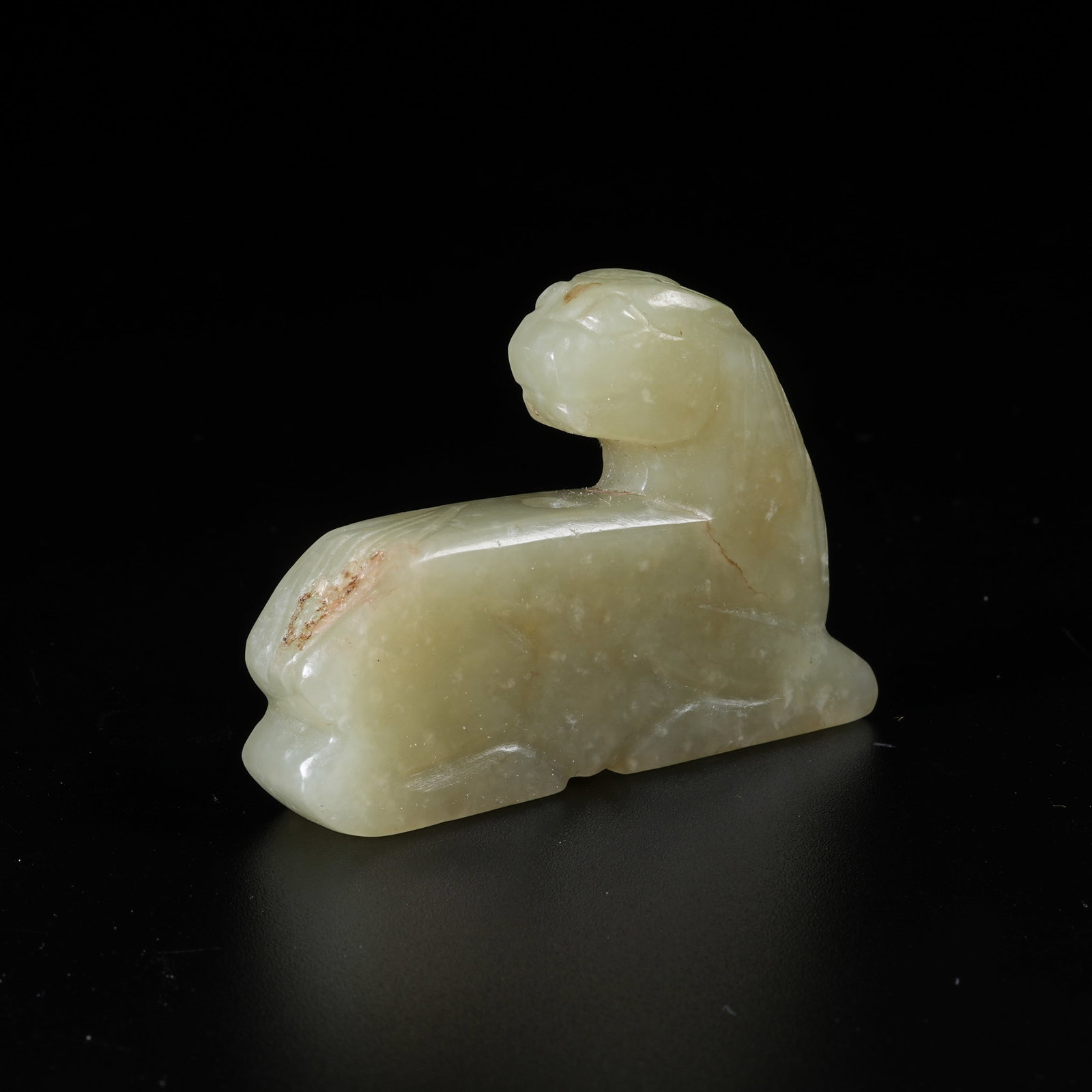 A HETIAN JADE RECUMBENT BEAST PENDANT: Hetian Jade Recumbent Beast Pendant