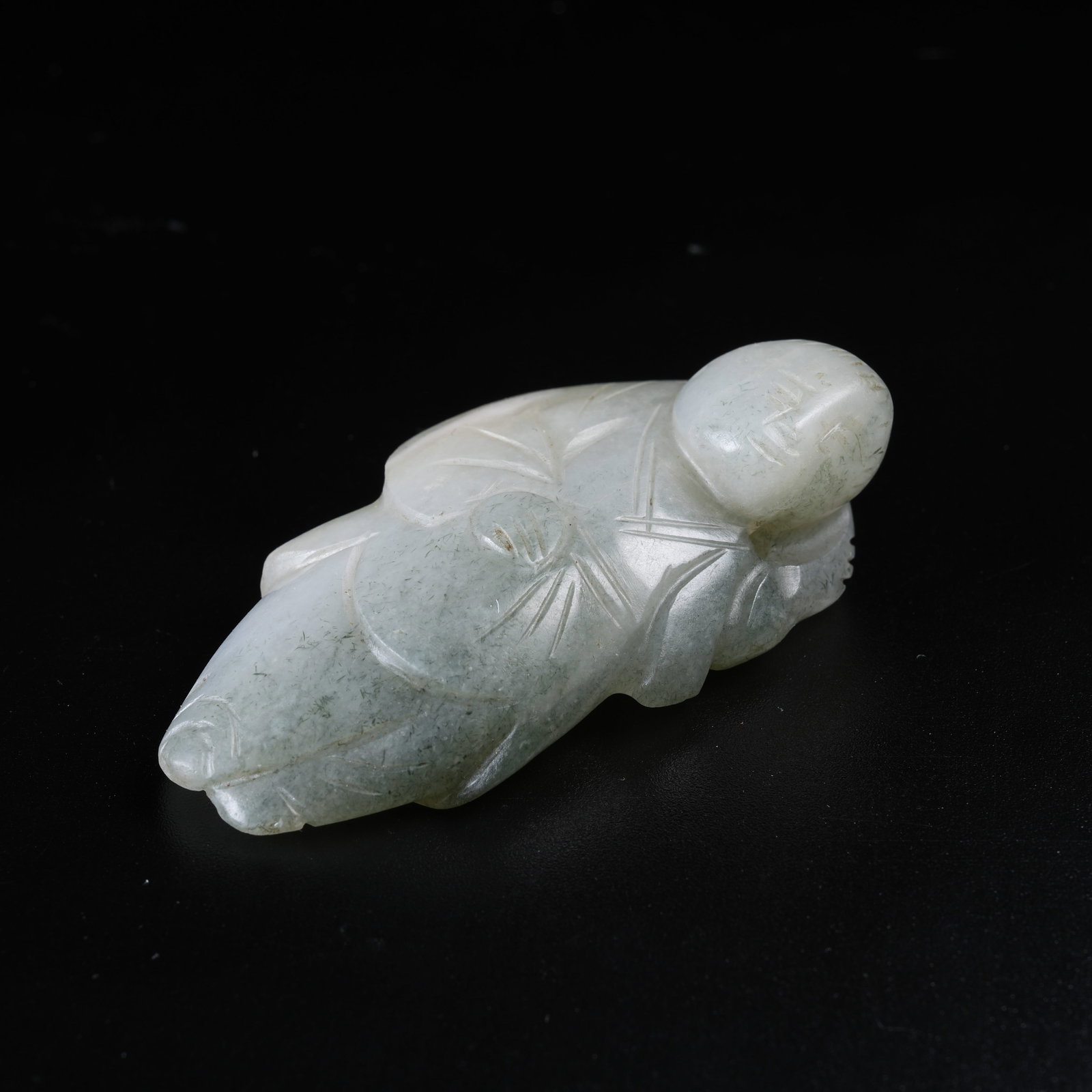 A HETIAN JADE HANGING ORNAMENT OF RECUMBENT BOY: Hetian Jade Hanging Ornament of Recumbent Boy