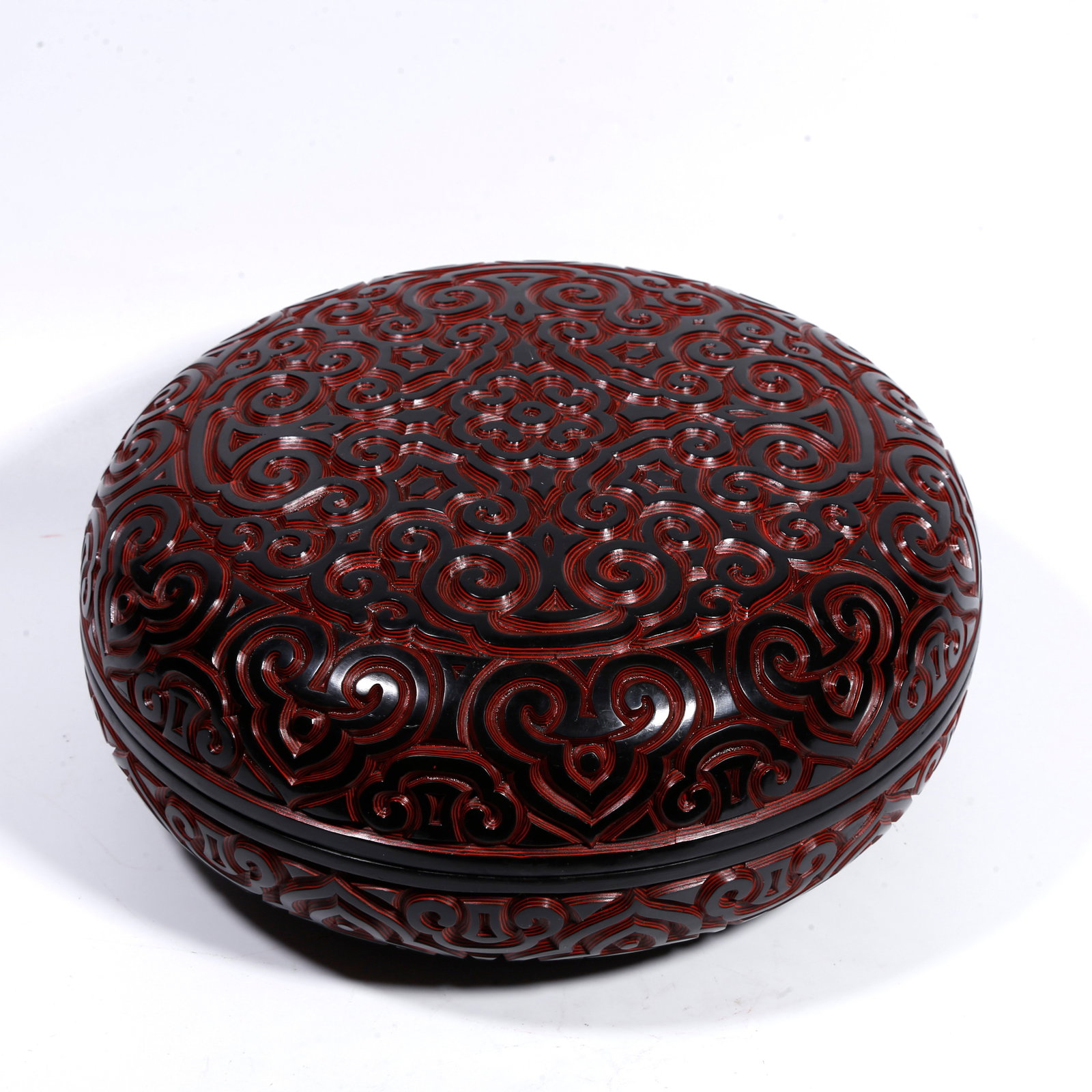 A CARVED-BLACK-RED HAND-HELD BOX WITH AUSPICIOUS-CLOUD PATTERN: Carved-black-red hand-held box with auspicious-cloud pattern