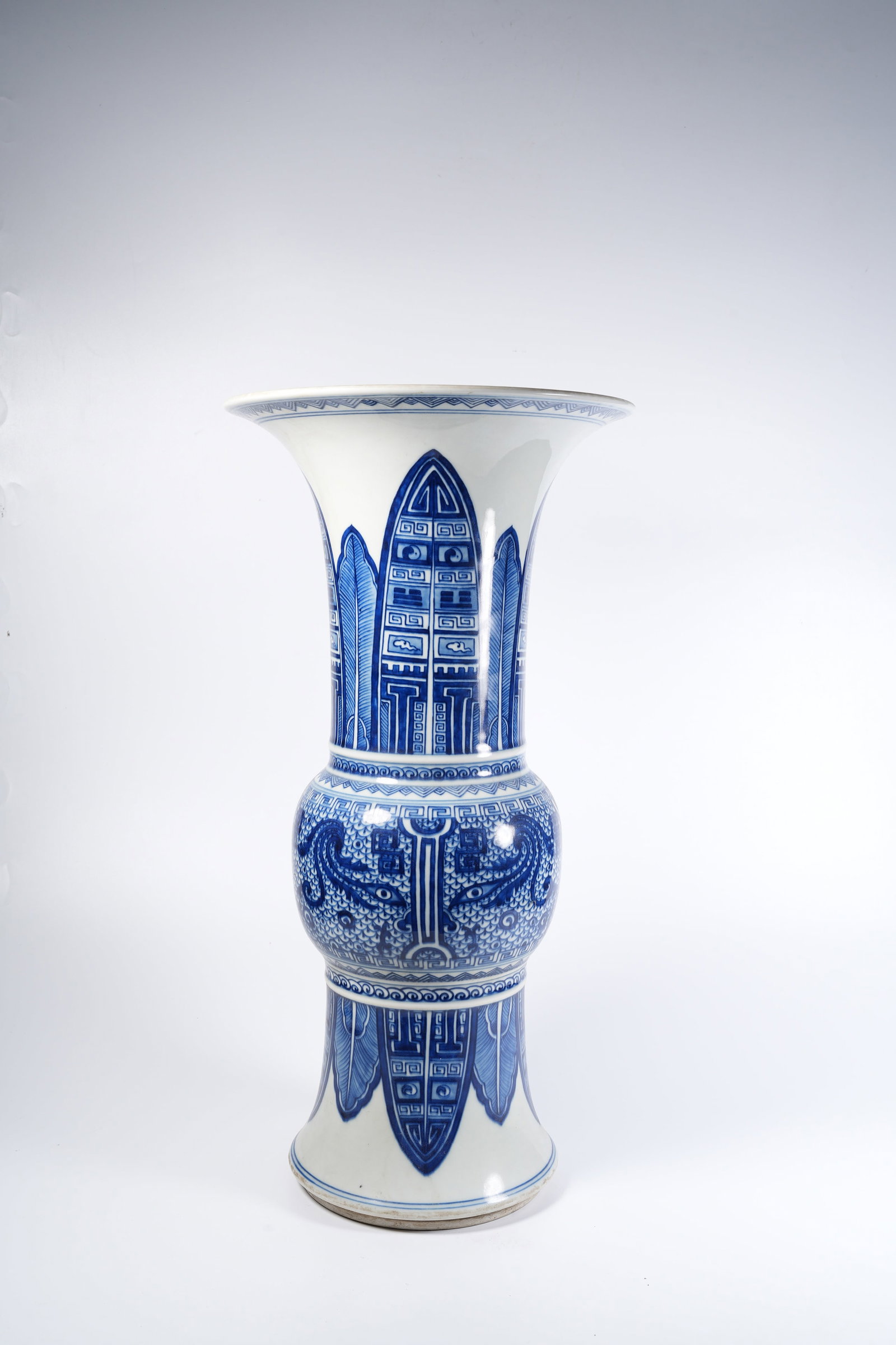 A BLUE-AND-WHITE GU-FORM BEAKER WITH BEAST-MASK PATTERN: Blue-and-white gu-form beaker with beast-mask pattern