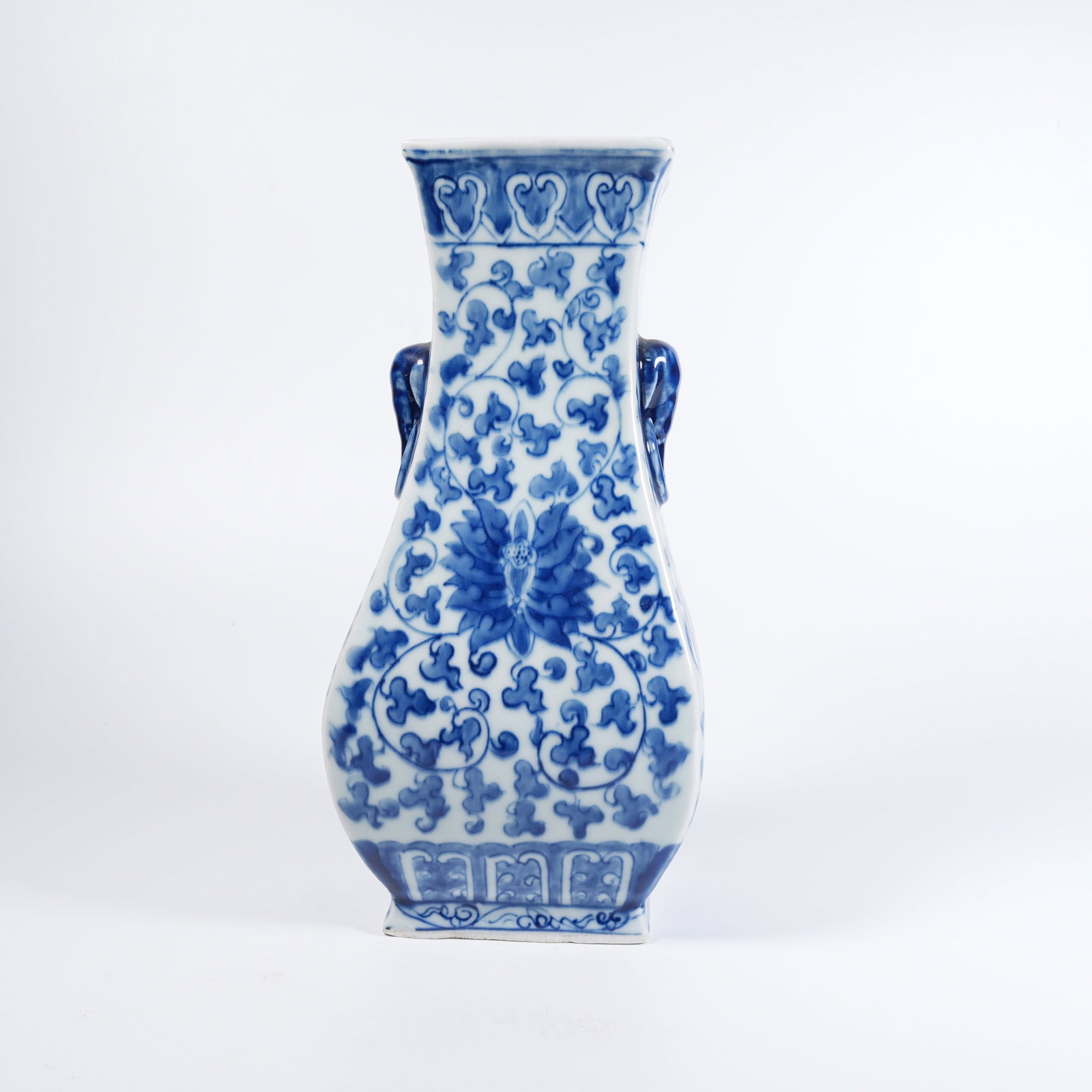 A BLUE-AND-WHITE ZUN WITH ELEPHANT-SHAPED EARS AND PLUCKED-BRANCH FLORAL PATTERN: Blue-and-white zun with elephant-shaped ears and plucked-branch floral pattern
