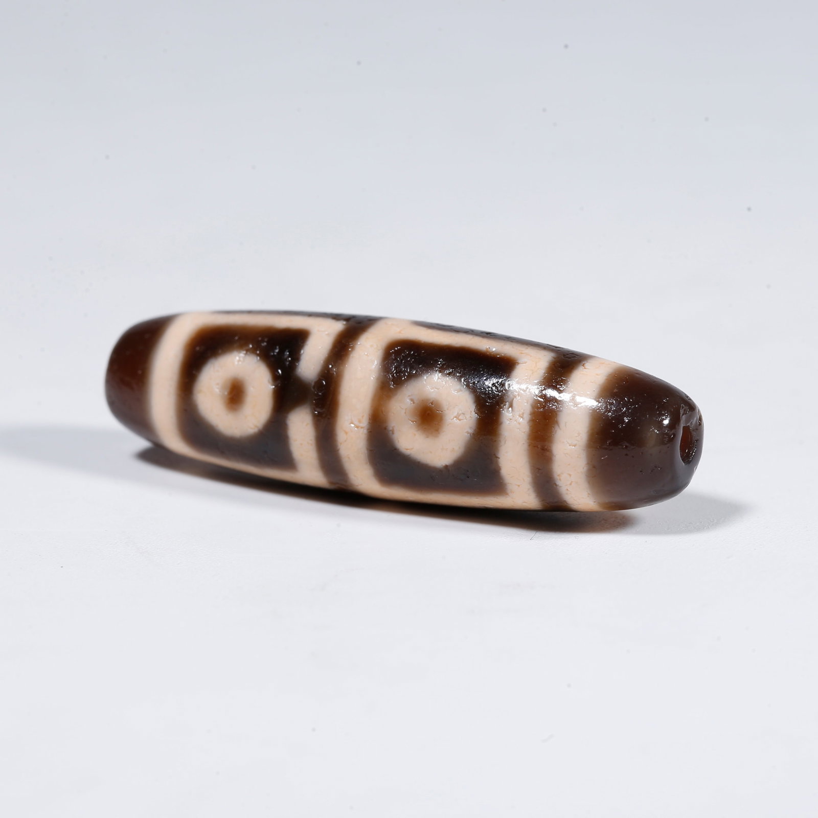 A FOUR-EYED DZI BEAD (1 of 9)