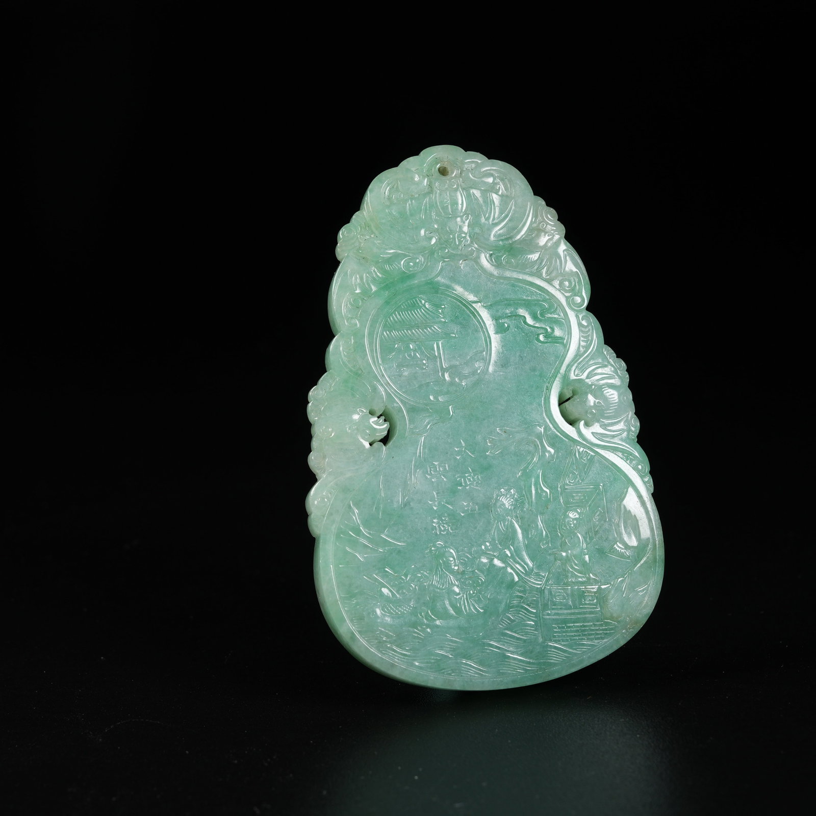 A JADEITE GOURD-SHAPED PLAQUE OF IMMORTAL RIDING RAFT (1 of 8)
