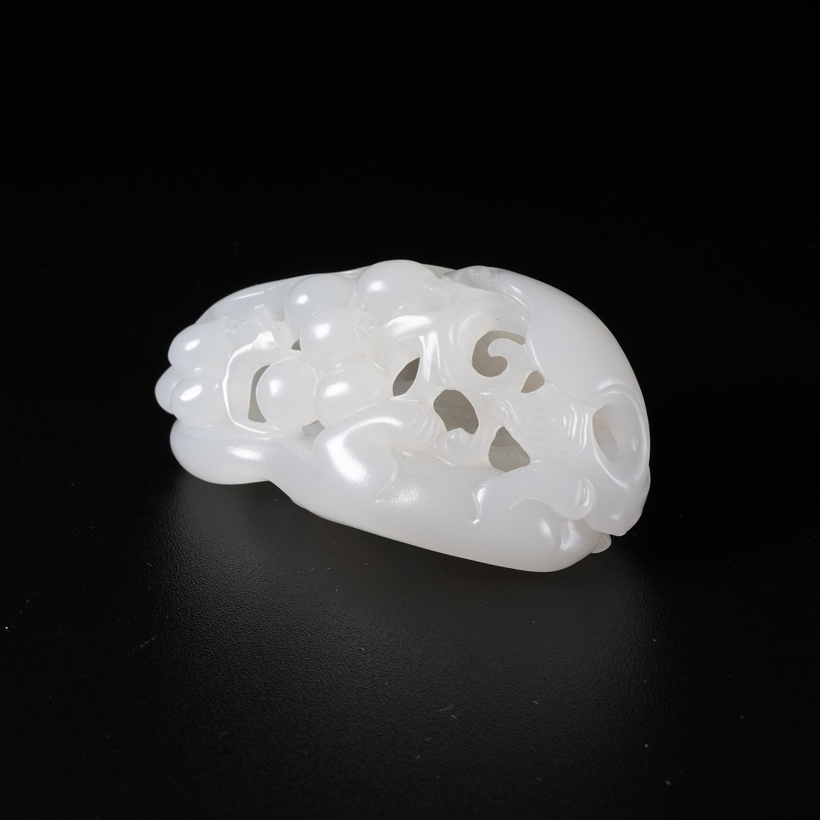 A ORNAMENT OF SQUIRREL AND GRAPE IN WHITE HETIAN JADE: Ornament of squirrel and grape in white Hetian jade