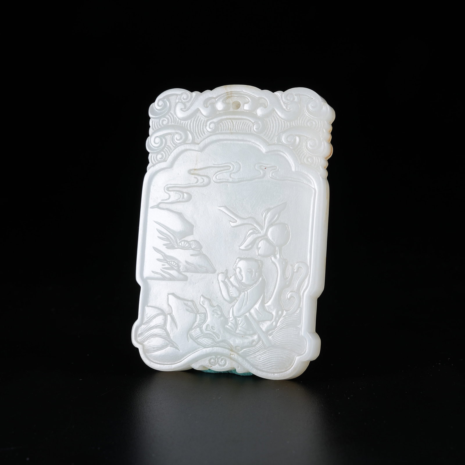 A HETIAN JADE PLAQUE CARVED WITH BOY RIDING RAFT MOTIF: Hetian Jade Plaque Carved with Boy Riding Raft Motif