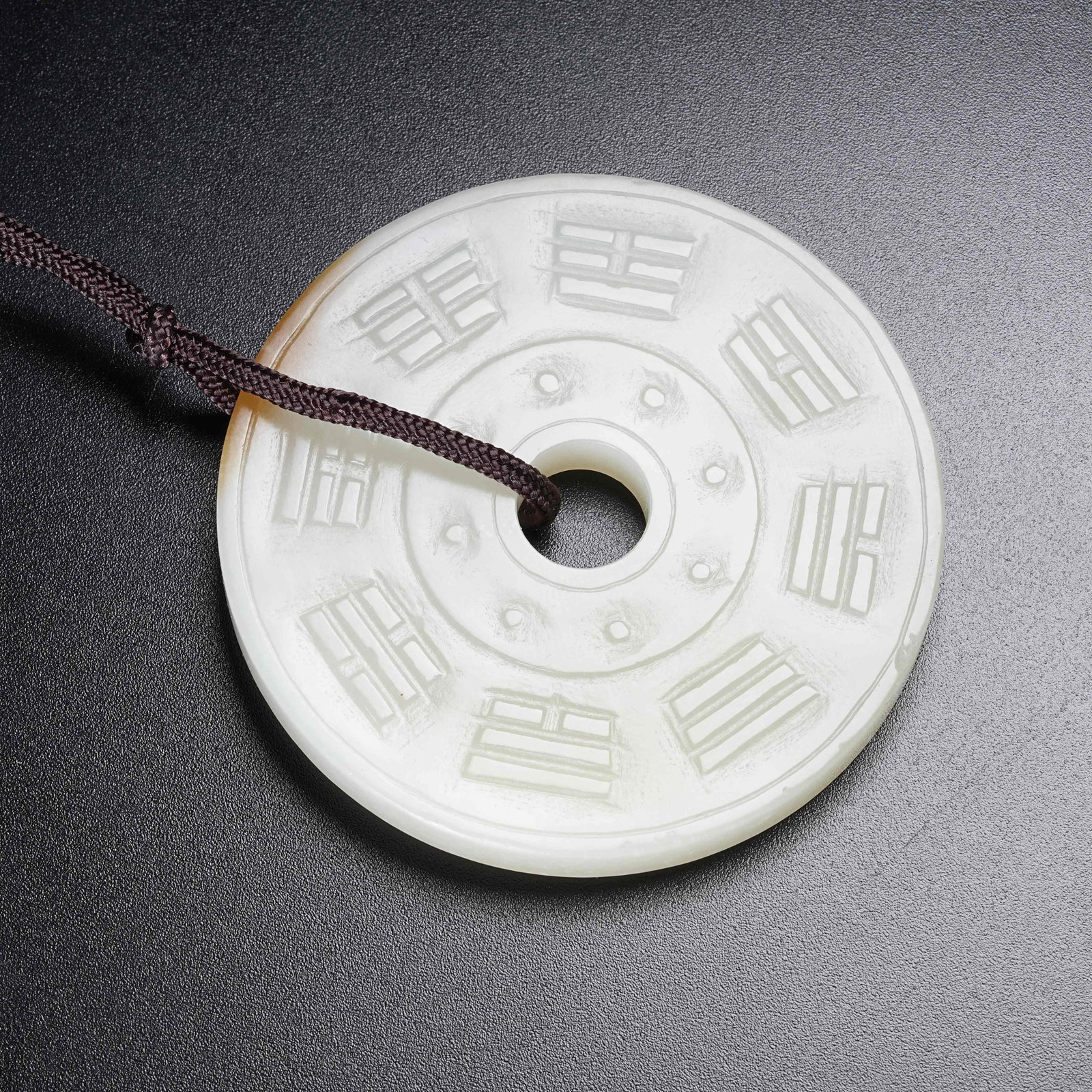 A HETIAN JADE BI DISC WITH EIGHT TRIGRAMS PATTERN: Hetian Jade Bi Disc with Eight Trigrams Pattern