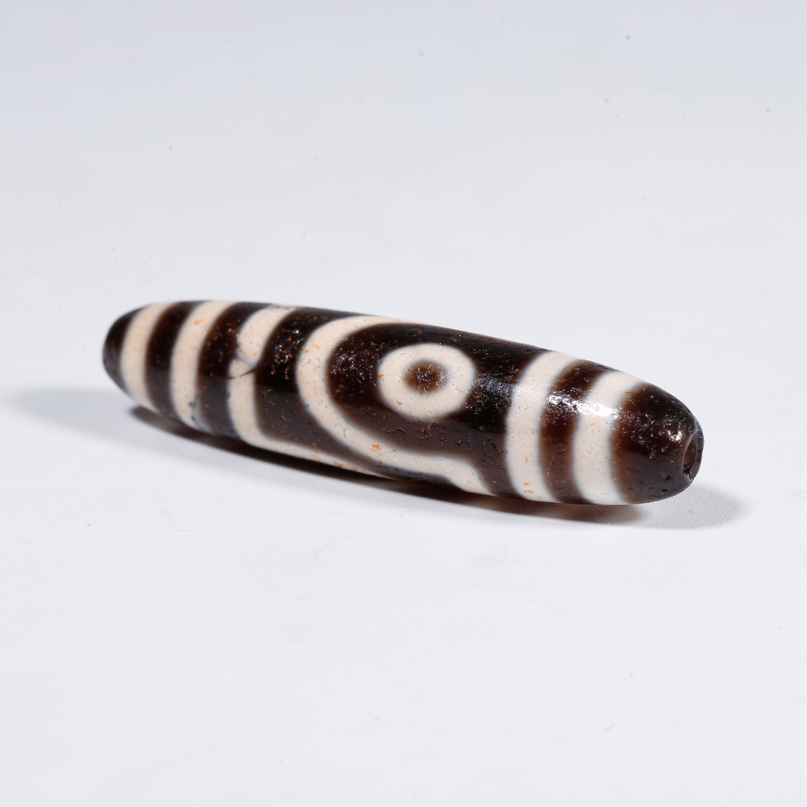 A TWO-EYED DZI BEAD (1 of 9)