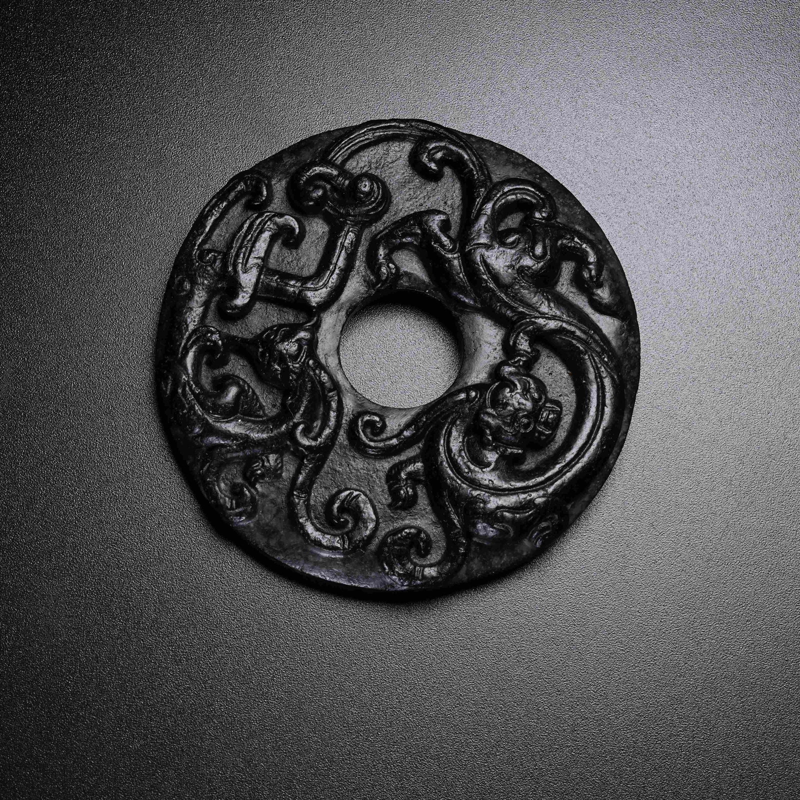 A ANCIENT JADE BI DISC WITH CHI DRAGON PATTERN: Ancient Jade Bi Disc with Chi Dragon Pattern