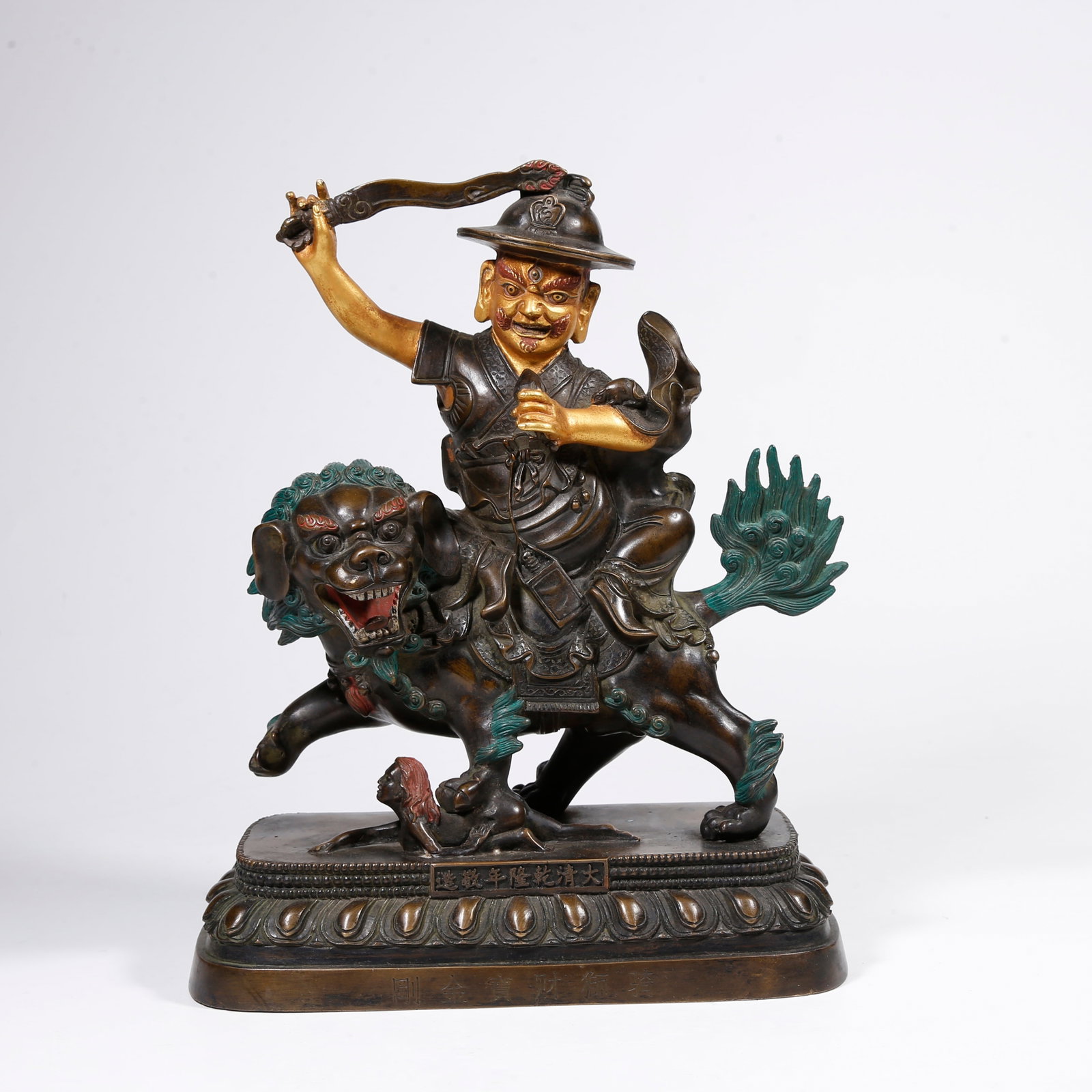 A PART-GILT-BRONZE DHARMA PROTECTOR STATUE: Part-gilt-bronze Dharma protector statue