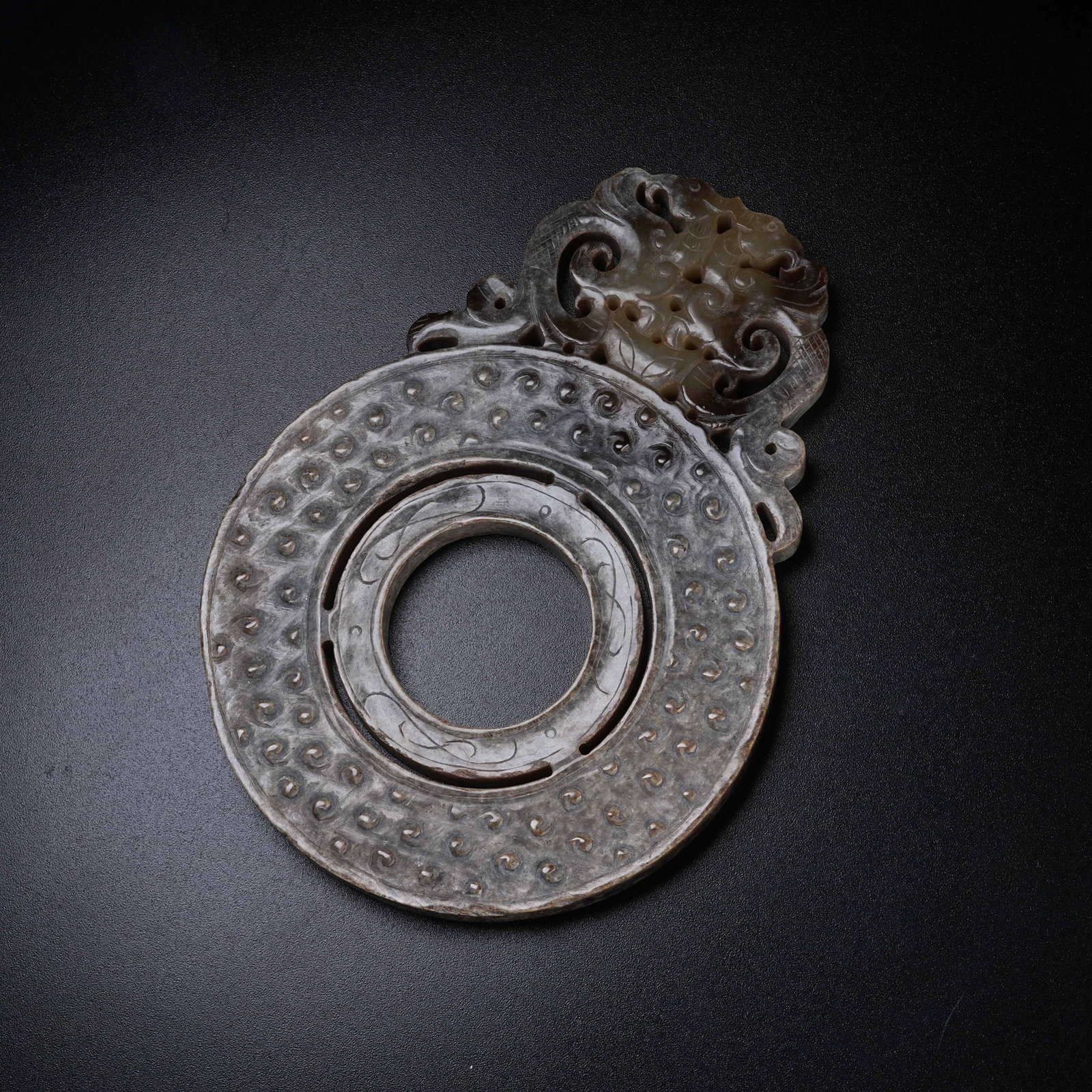A ARCHAIC JADE OPENWORK BI WITH DIVINE PHOENIX PATTERN: Archaic Jade Openwork Bi with Divine Phoenix Pattern