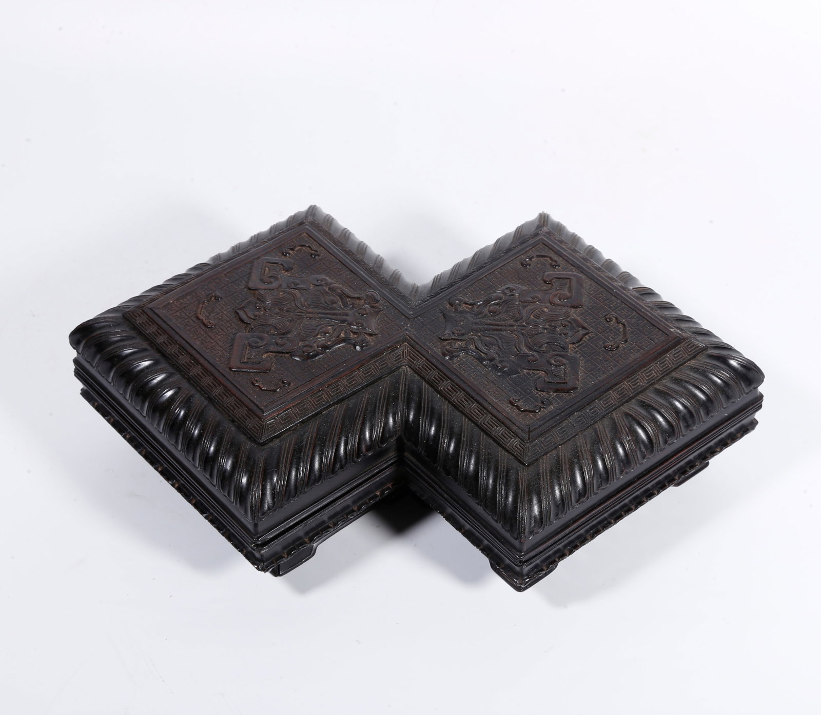A RED SANDALWOOD RHOMBUS-SHAPED COVERED BOX CARVED WITH BEAST-MASK PATTERN: Red sandalwood rhombus-shaped covered box carved with beast-mask pattern
