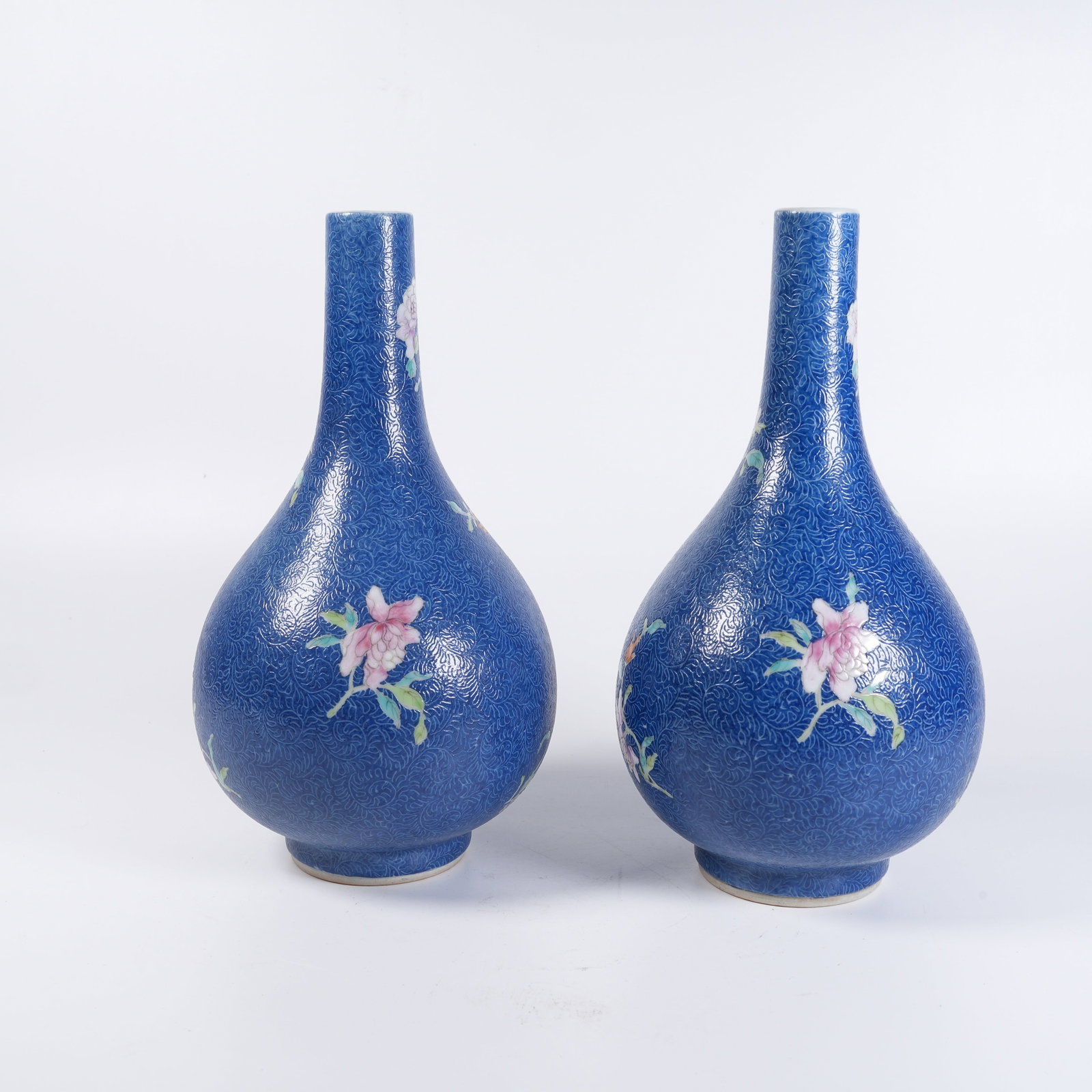 A SET OF BLUE-GROUND FAMILLE-ROSE GRAVED-GROUND FLORAL GALL-SHAPED VASES: Set of blue-ground famille-rose graved-ground floral gall-shaped vases