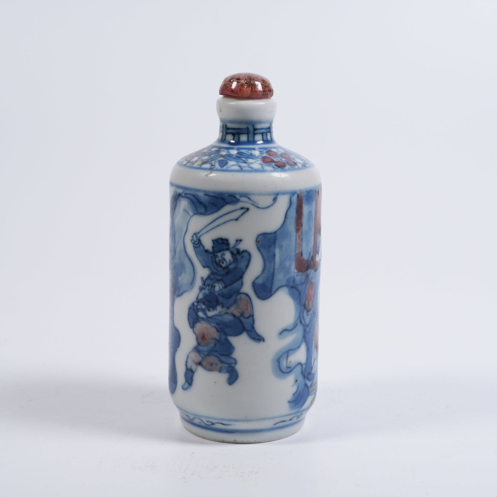 A BLUE-AND-WHITE UNDERGLAZE-RED FIGURED SNUFF BOTTLE: Blue-and-white underglaze-red figured snuff bottle