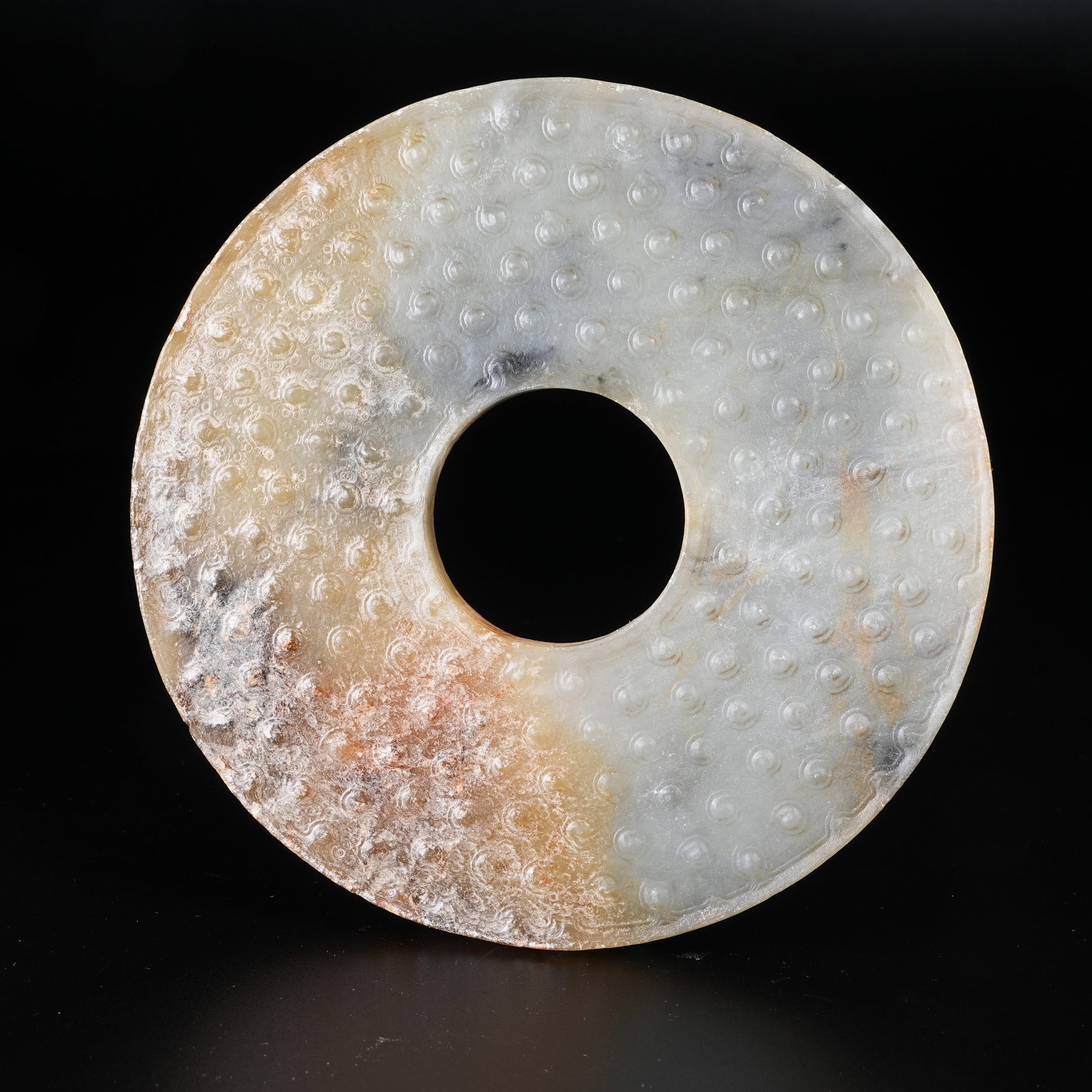 A ARCHAIC JADE BI WITH STUD PATTERN: Archaic Jade Bi with Stud Pattern