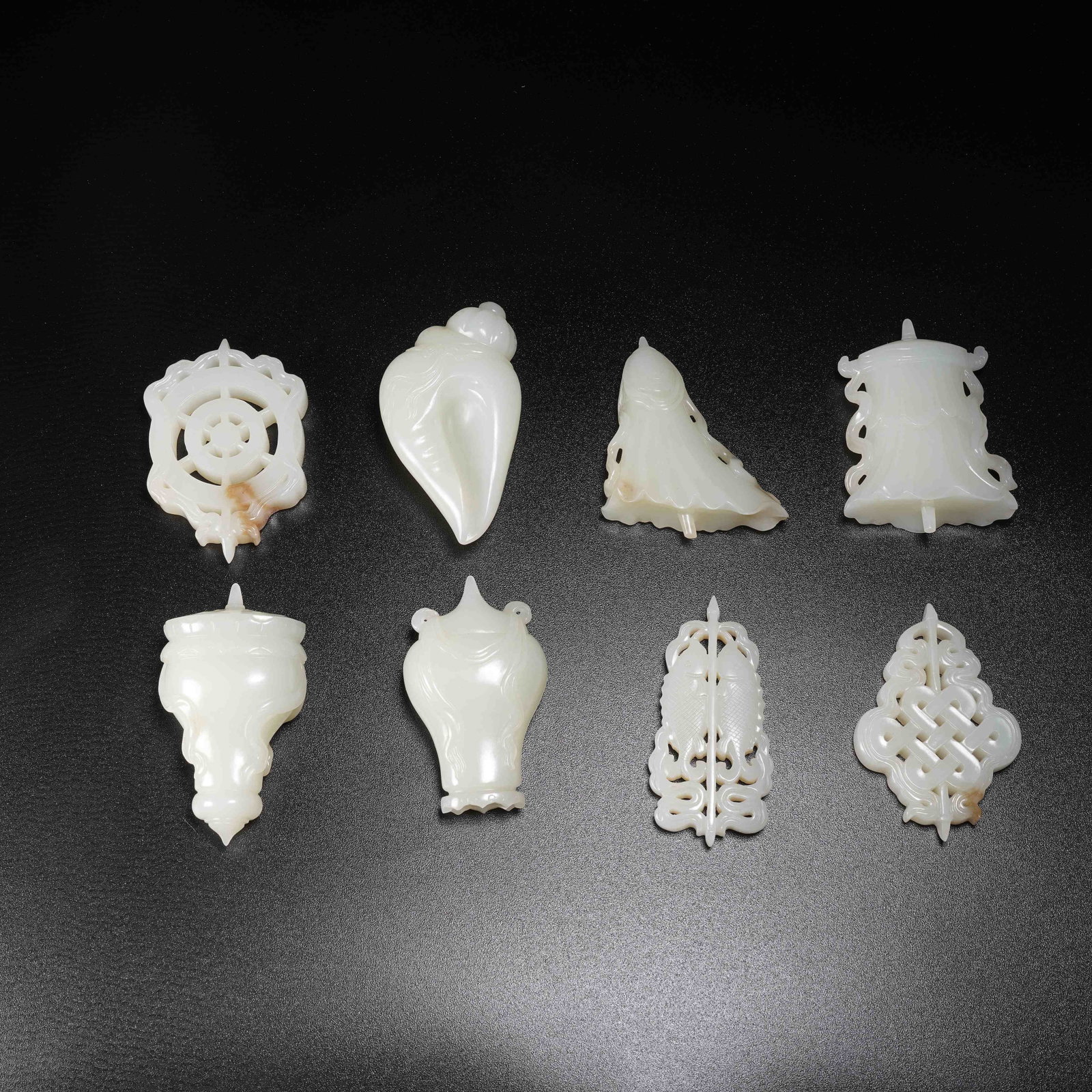 A SET OF EIGHT-AUSPICIOUS-SYMBOL RITUAL VESSELS IN WHITE HETIAN JADE (1 of 9)