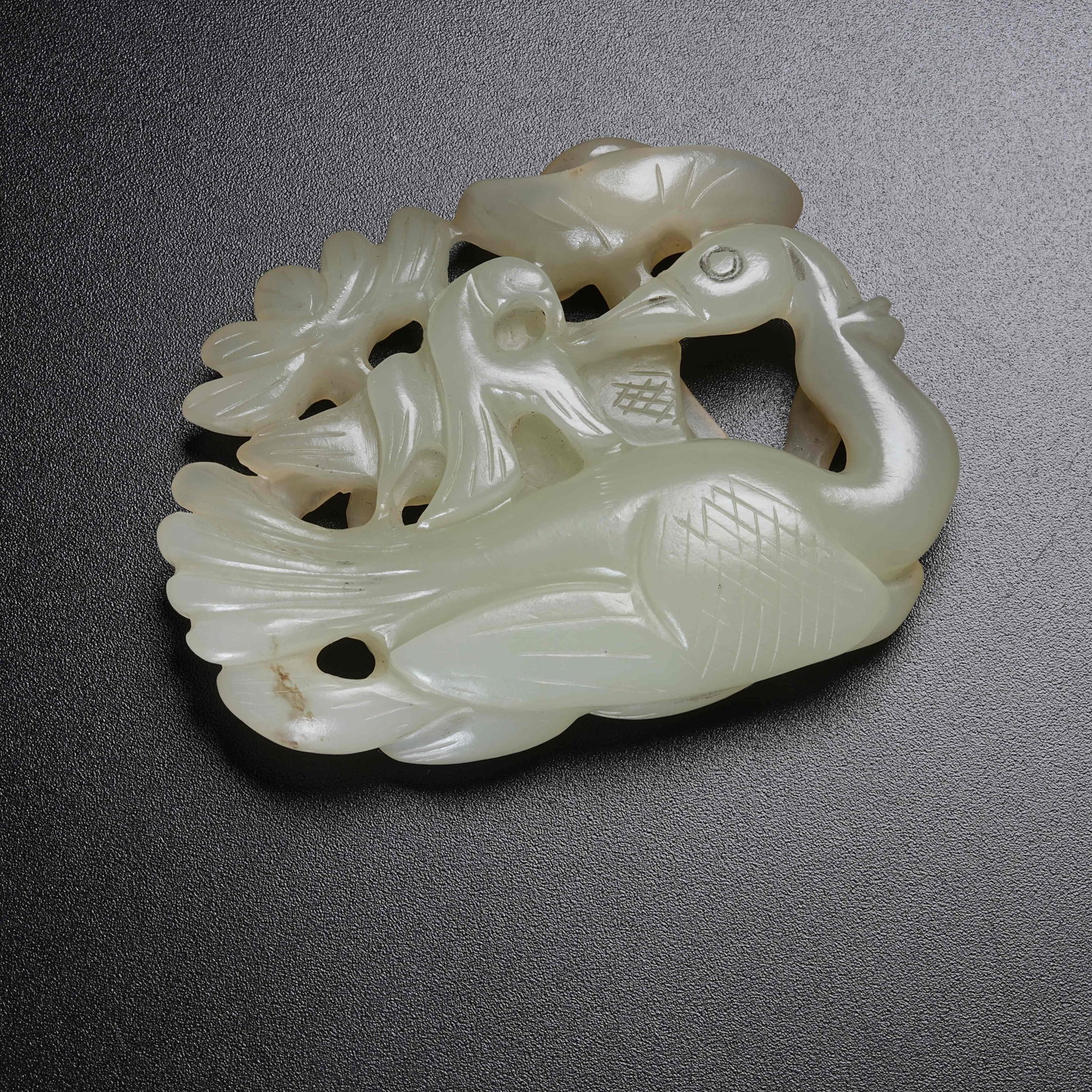 A HETIAN JADE PENDANT DEPICTING GYRFALCON HUNTING WILD GOOSE: Hetian Jade Pendant Depicting Gyrfalcon Hunting Wild Goose