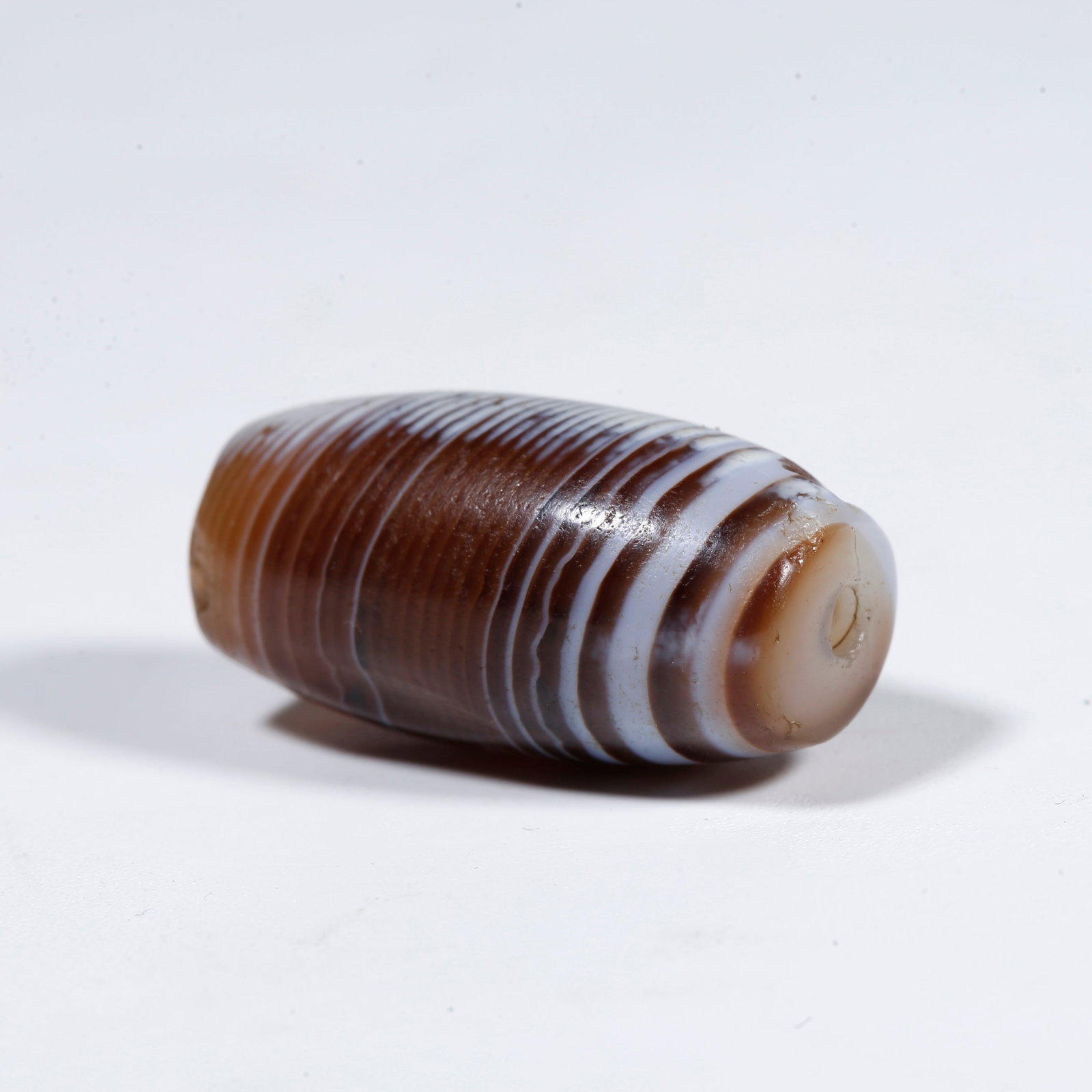A SILK-BANDED AGATE DZI BEAD (1 of 9)