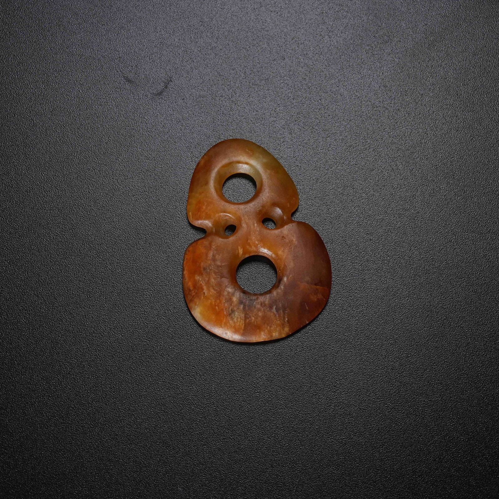 A ANCIENT JADE FIGURE-EIGHT RING: Ancient Jade Figure-Eight Ring