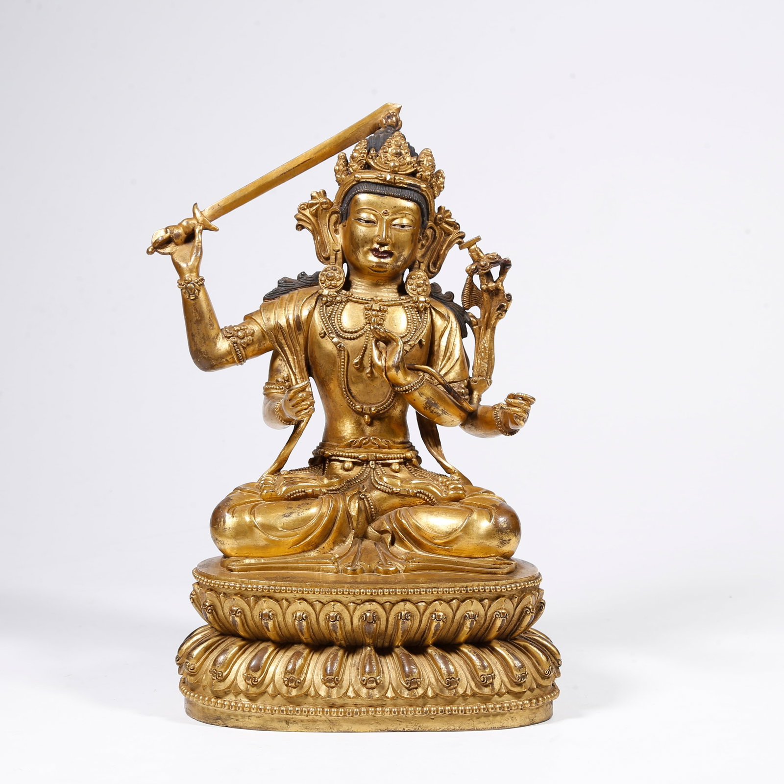 A GILT-BRONZE FOUR-ARMED MANJUSHRI BUDDHA STATUE (1 of 9)
