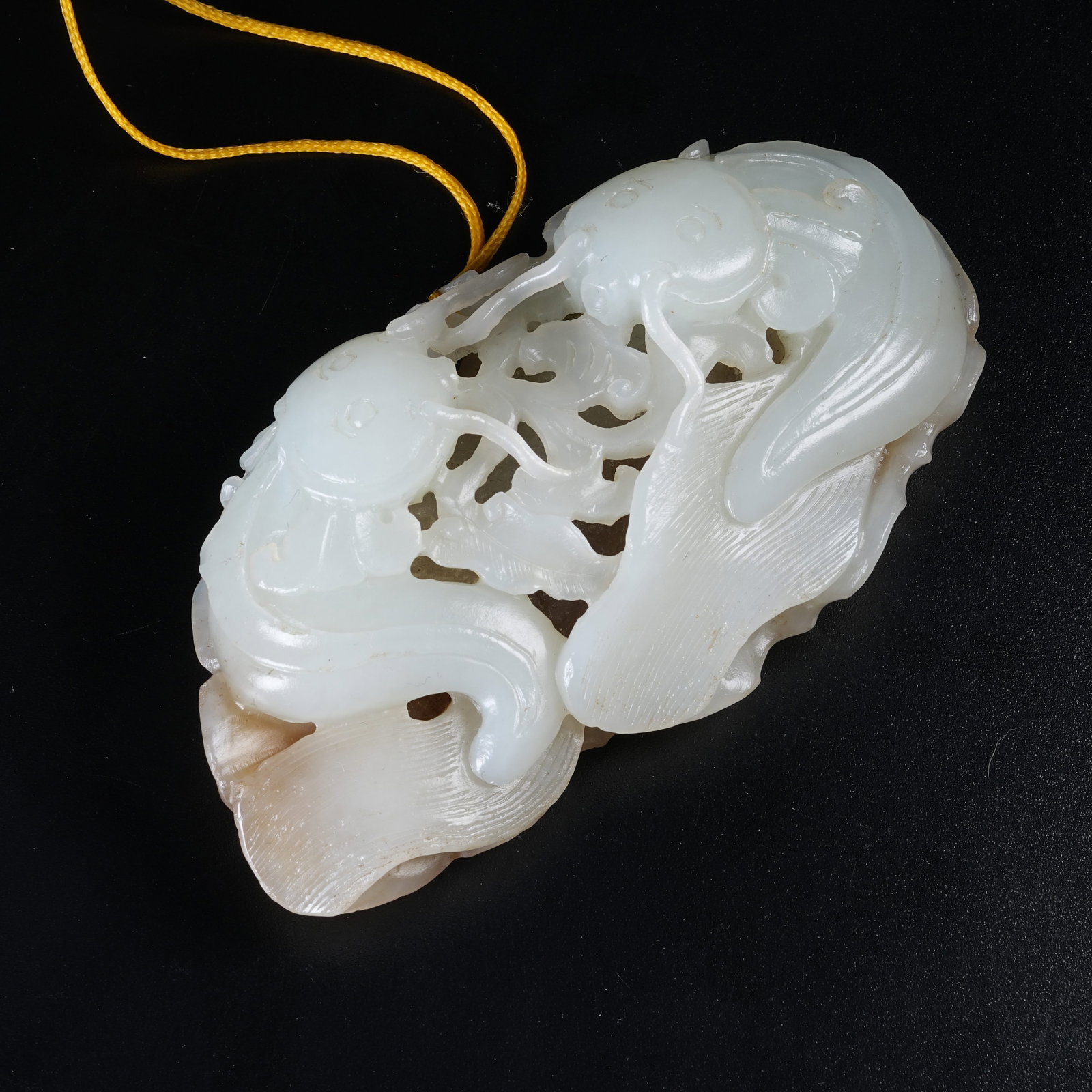 A HETIAN JADE HANGING ORNAMENT SYMBOLIZING ABUNDANT SURPLUS YEAR AFTER YEAR: Hetian Jade Hanging Ornament Symbolizing Abundant Surplus Year After Year