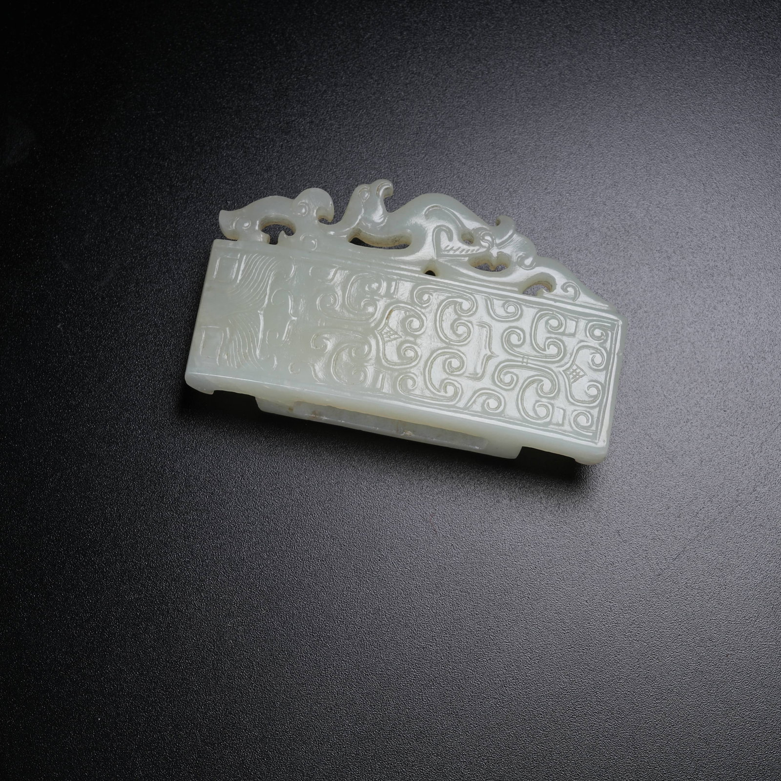 A HETIAN JADE SWORD GUARD WITH CHI DRAGON PATTERN (1 of 8)