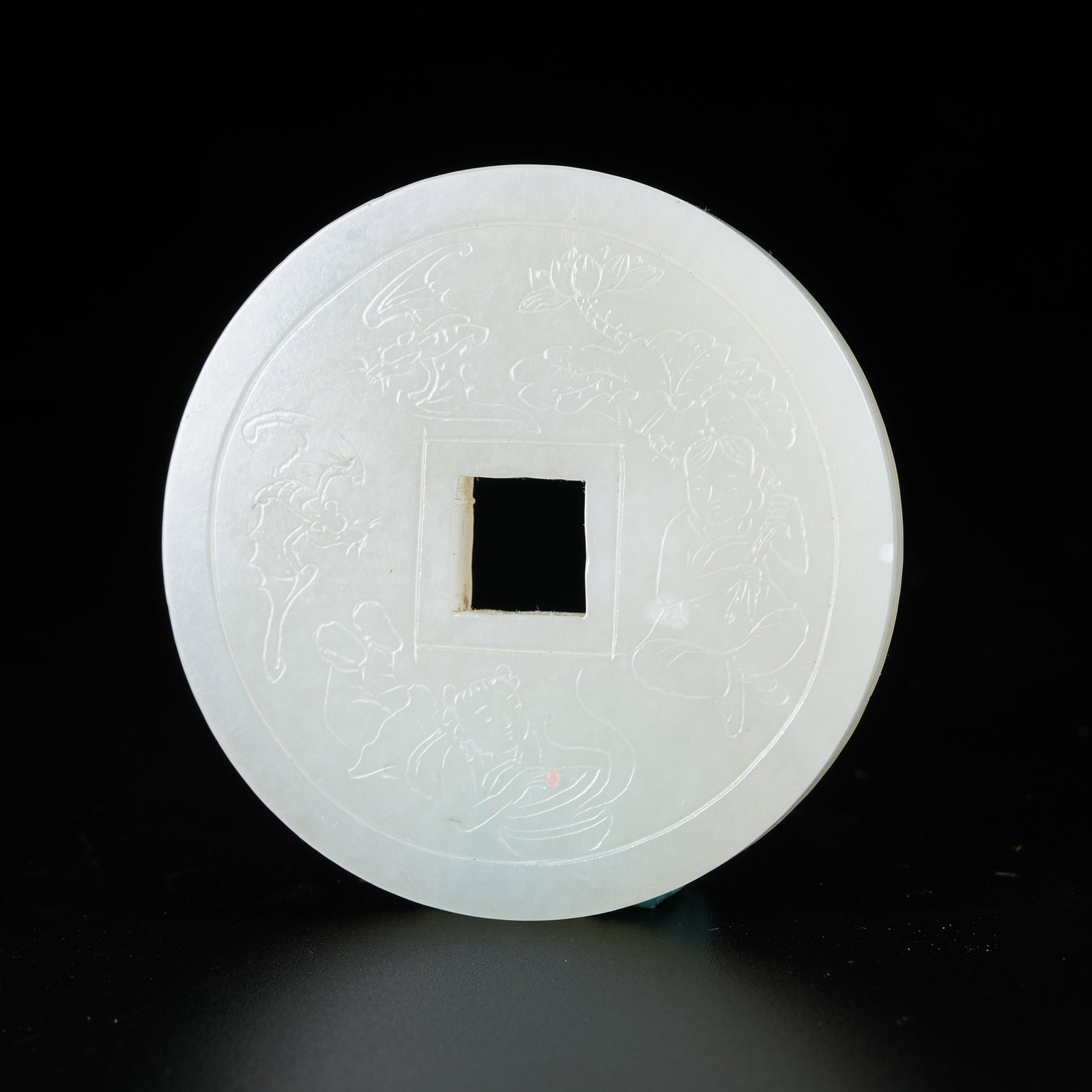 A HETIAN JADE AMULET COIN CARVED WITH TWO IMMORTALS OF HARMONY (1 of 10)