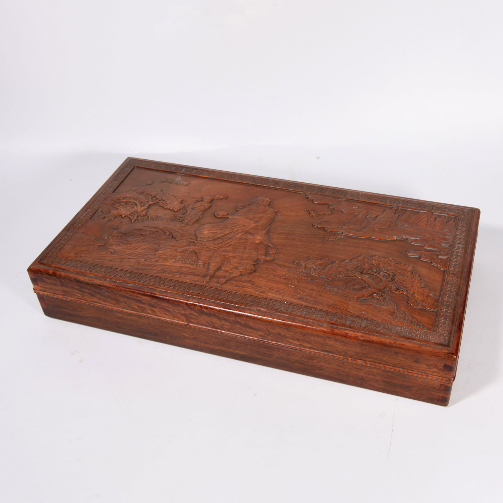 A HUANGHUALI WOOD COVERED BOX CARVED WITH LANDSCAPE-AND-FIGURE PATTERN: Huanghuali wood covered box carved with landscape-and-figure pattern