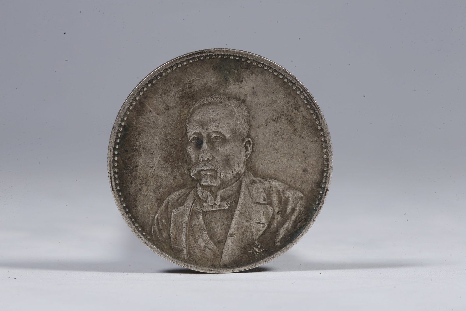 A SILVER DOLLAR COIN - 3