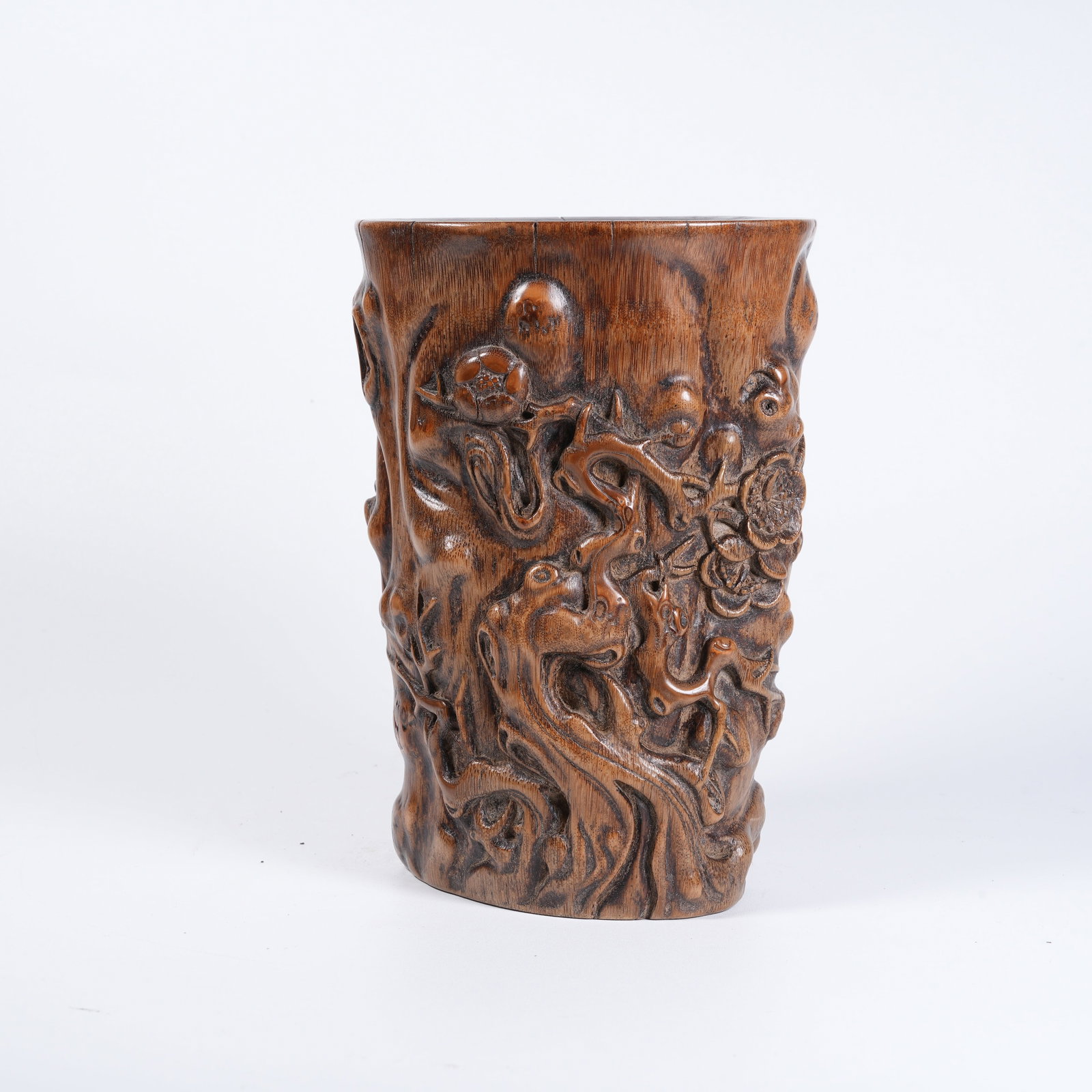 A BAMBOO-ROOT CARVED PLUM-BLOSSOM-PATTERN BRUSH POT: Bamboo-root carved plum-blossom-pattern brush pot