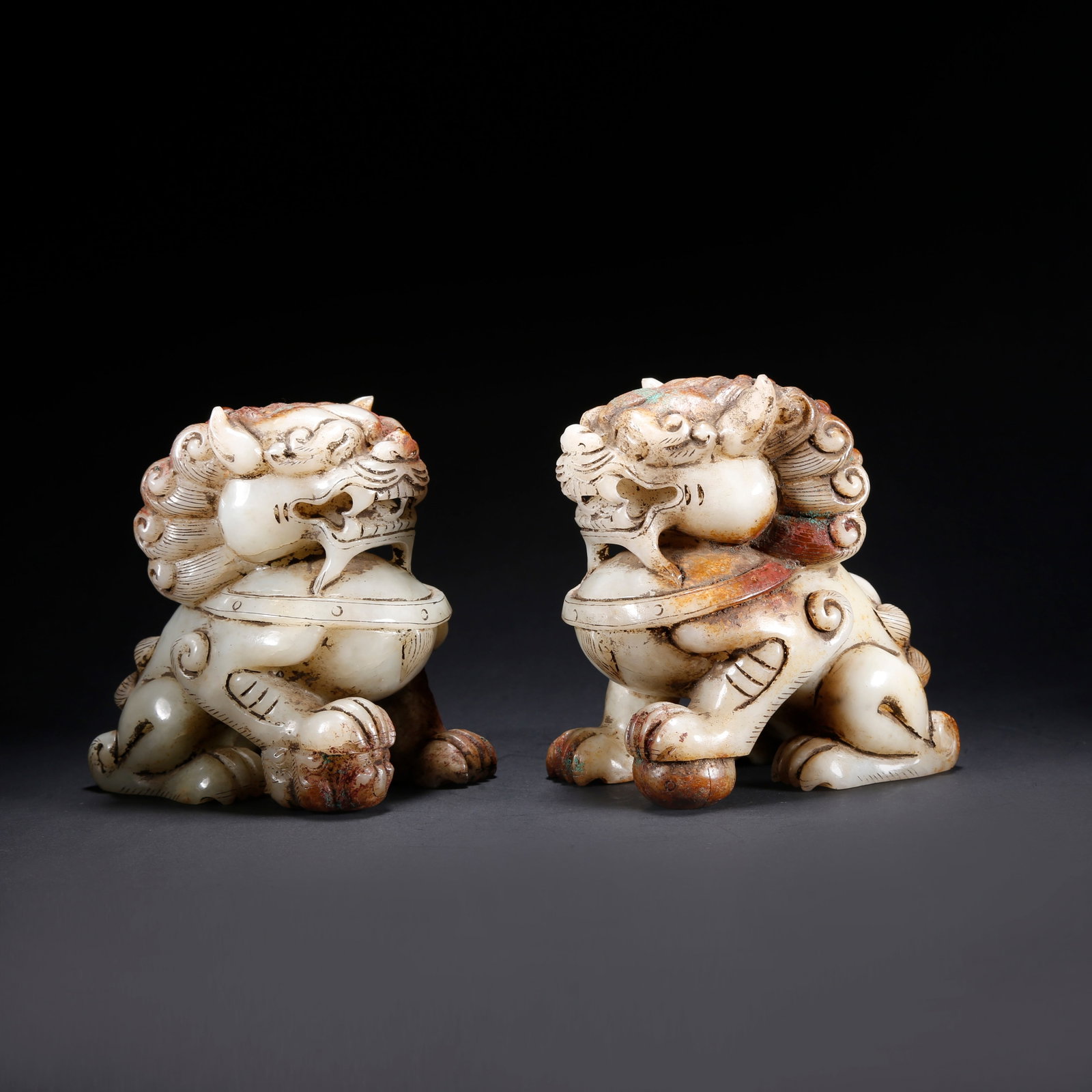 A PAIR OF HETIAN JADE LION ORNAMENTS: Pair of Hetian Jade Lion Ornaments
