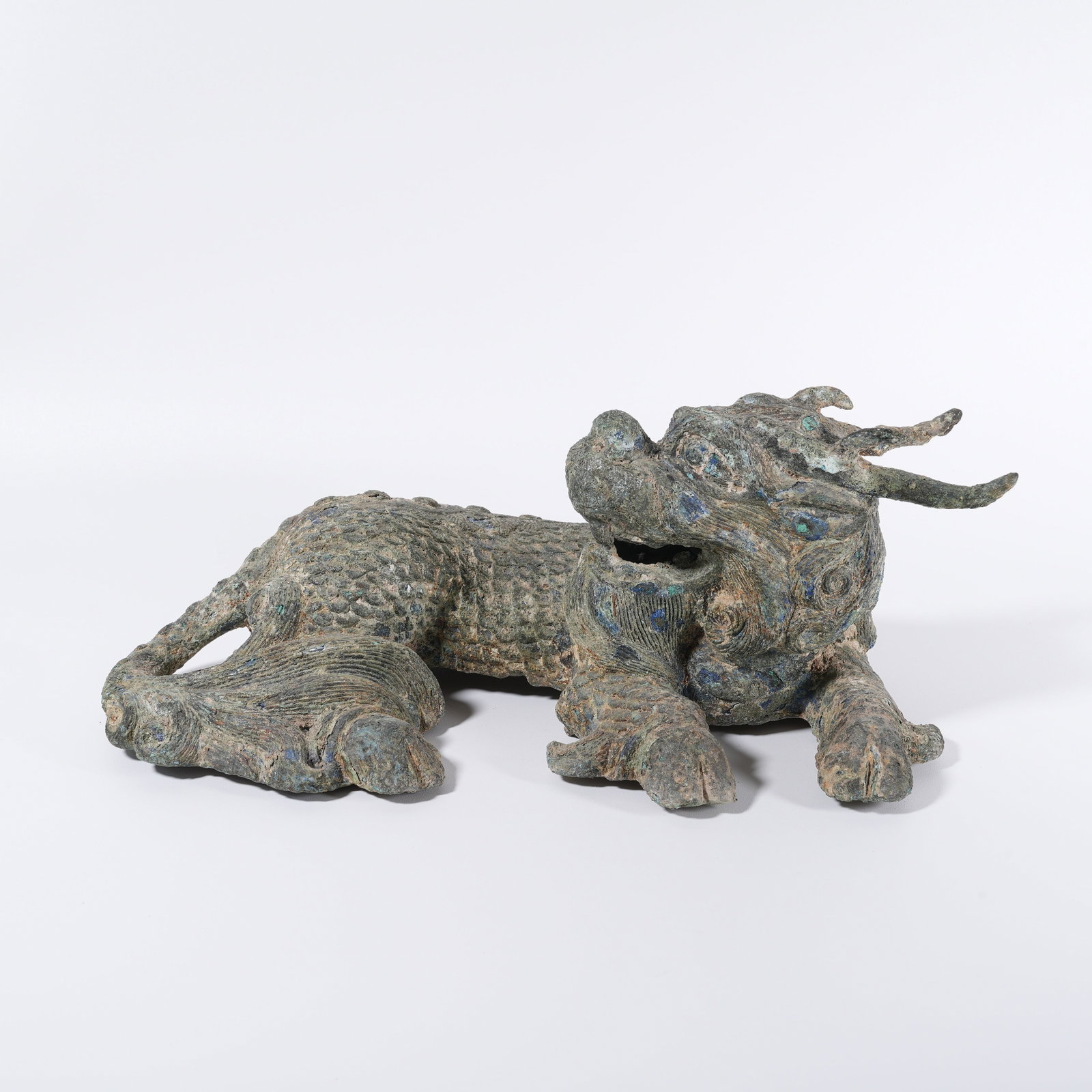 A BRONZE KYLIN-SHAPED ORNAMENT: Bronze kylin-shaped ornament