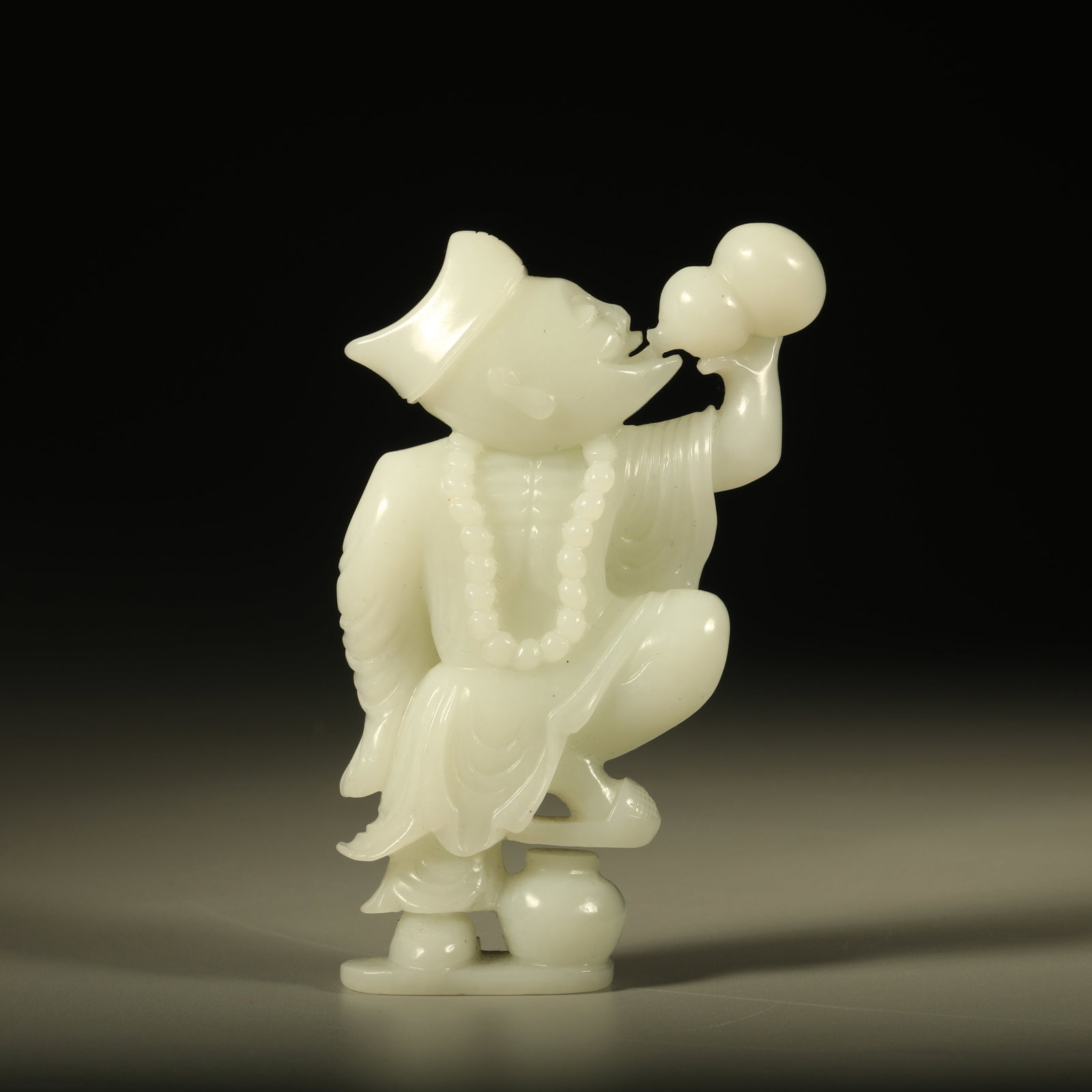 A HETIAN JADE CARVED JIGONG ORNAMENT: Hetian jade carved Jigong ornament