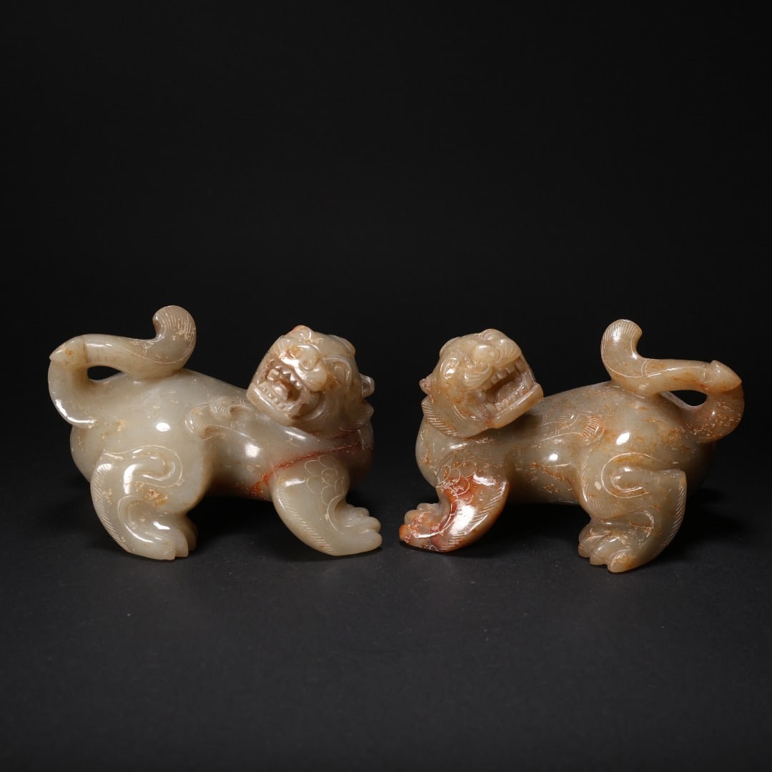 A PAIR OF AUSPICIOUS BEASTS MADE OF HETIAN JADE: Length 10 cm, Width 7.2 cm, Height 6.4 cm, Total weight of a pair: 779 g