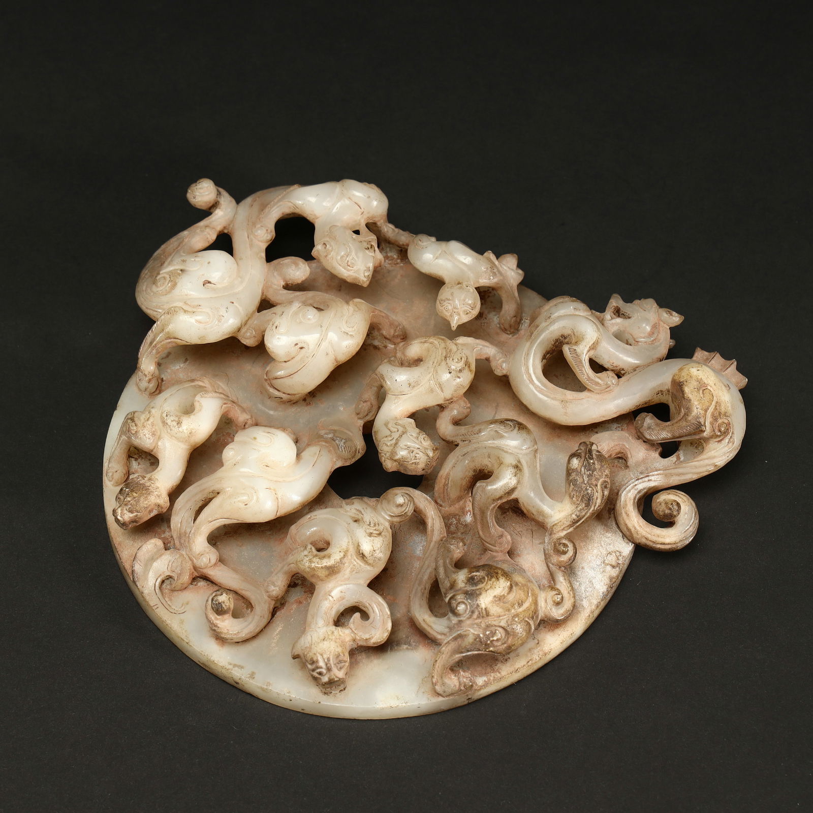 HAN DYNASTY HIGH-RELIEF JADE BI WITH DOUBLE CHI DRAGON DESIGN: Length 15.5cm, Width 13.5cm