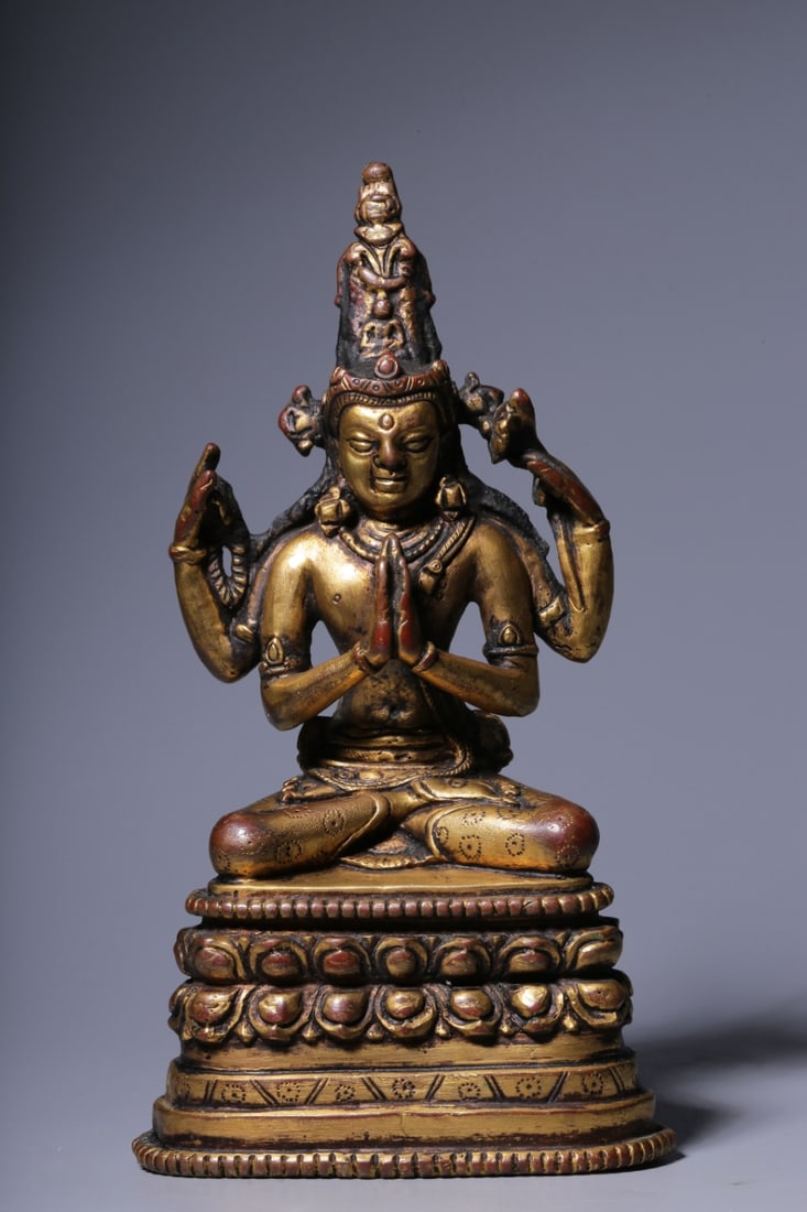 QING DYNASTY, GILT BRONZE FOUR-ARMED GUANYIN SEATED STATUE.: Height: 17cm