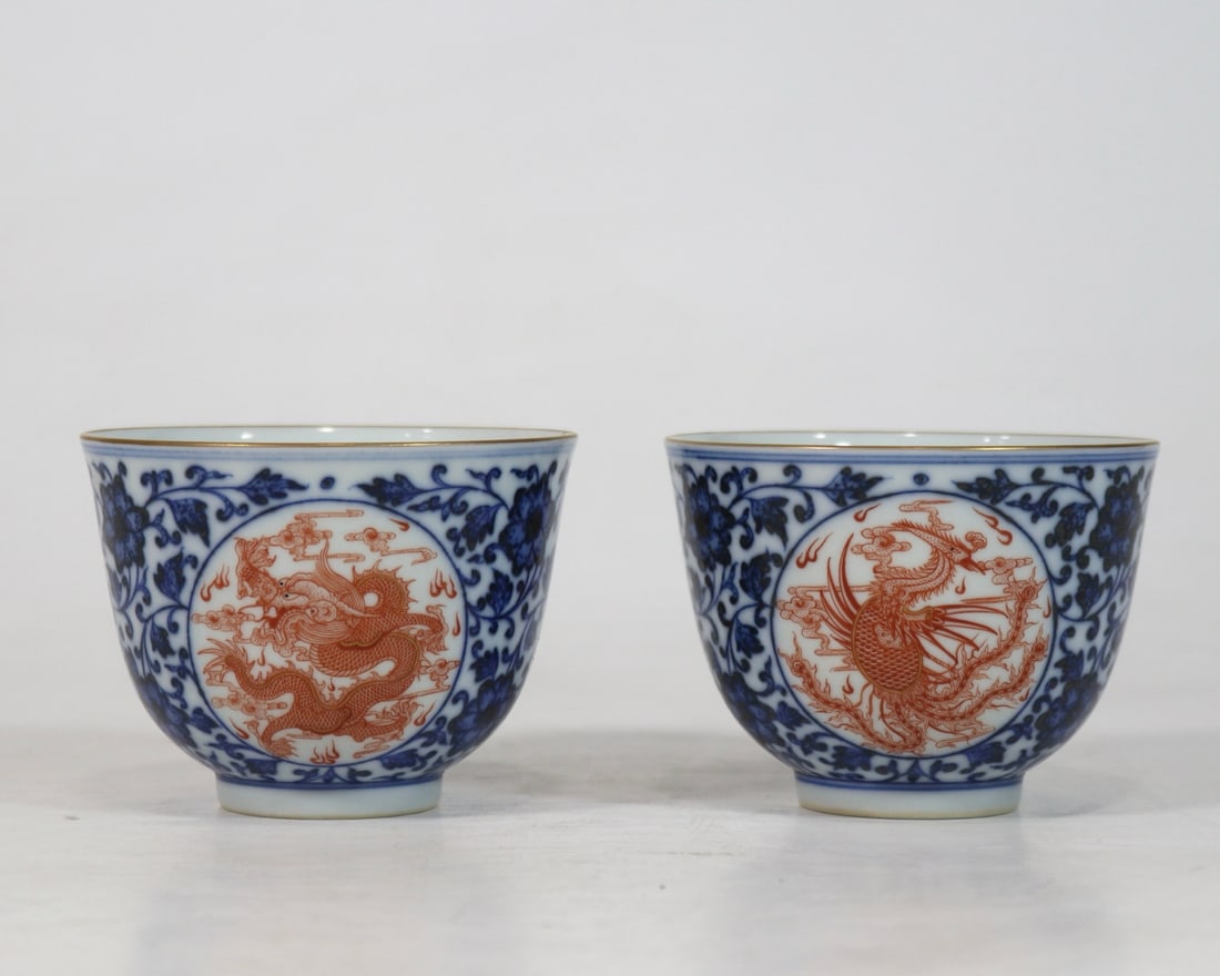BLUE AND WHITE PORCELAIN WITH IRON-RED DRAGON AND PHOENIX DESIGN - A PAIR OF AUSPICIOUS CUPS: Mouth diameter 8.8 cm, height 6.6 cm