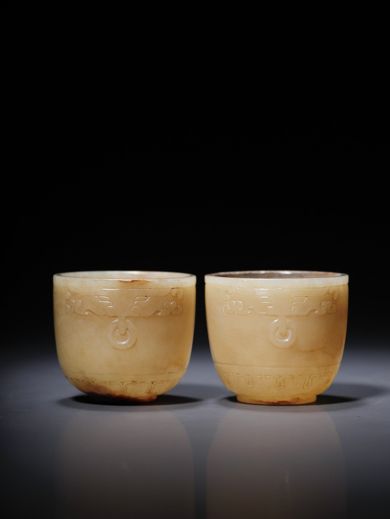 A PAIR OF JADE CUPS WITH ANIMAL FACE PATTERNS: Dimensions: Diameter 4.5 cm, Height 4.0 cm, Weight 93.2 g