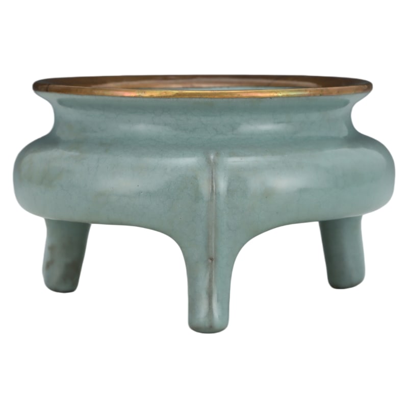 SONG DYNASTY CELADON-GLAZED TRIPOD CENSER: Height: 9.5 cm. Belly diameter: 16.2 cm.