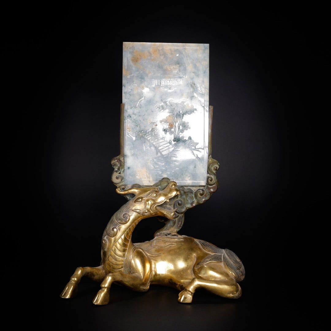 GILDED BRONZE AUSPICIOUS BEAST BASE WITH JADE LANDSCAPE AND POEM INSCRIPTION SCREEN: Length 26.5 cm, width 14.5 cm, height 37.5 cm, weight 2418 grams. Jade screen: Length 13.3 cm, width 0.6 cm, height 21.9 cm, weight 469 grams.