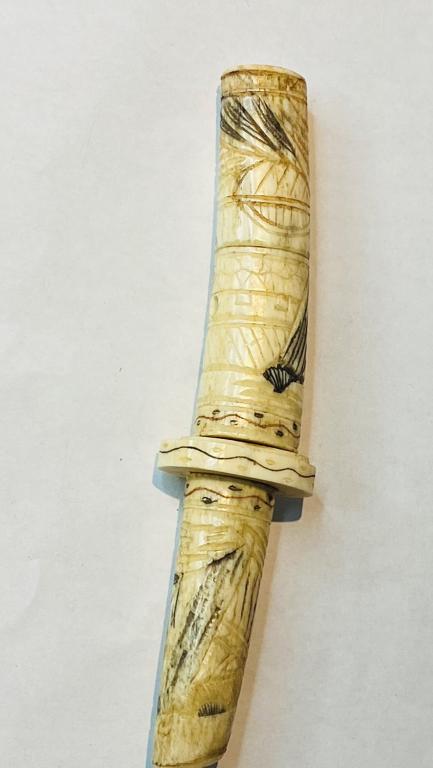 19th century Bone Dagger, Japan Chinese scabbard: Bone Dagger, Japan, 19th century, the scabbard finely carved in relief with samurai figures amidst a landscape with pavilions