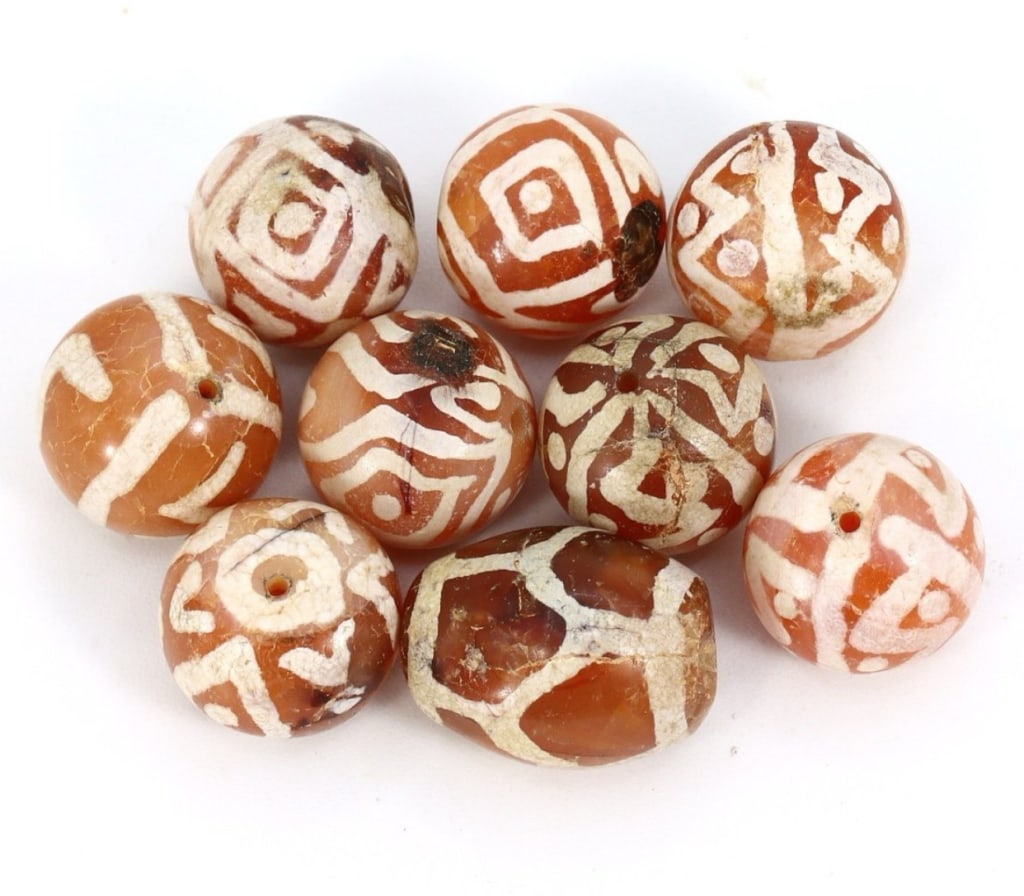 Group of 9 Medieval Himalayan Silk Road Tibetan E) Group of 9 Medieval Himalayan Silk Road Tibetan: Group of 9 Medieval Himalayan Silk Road Tibetan Etched Carnelian Dzi Beads (6th-17th Century AD) These 9 remarkable Tibetan etched carnelian dzi beads are a testament to the rich history of the Himala